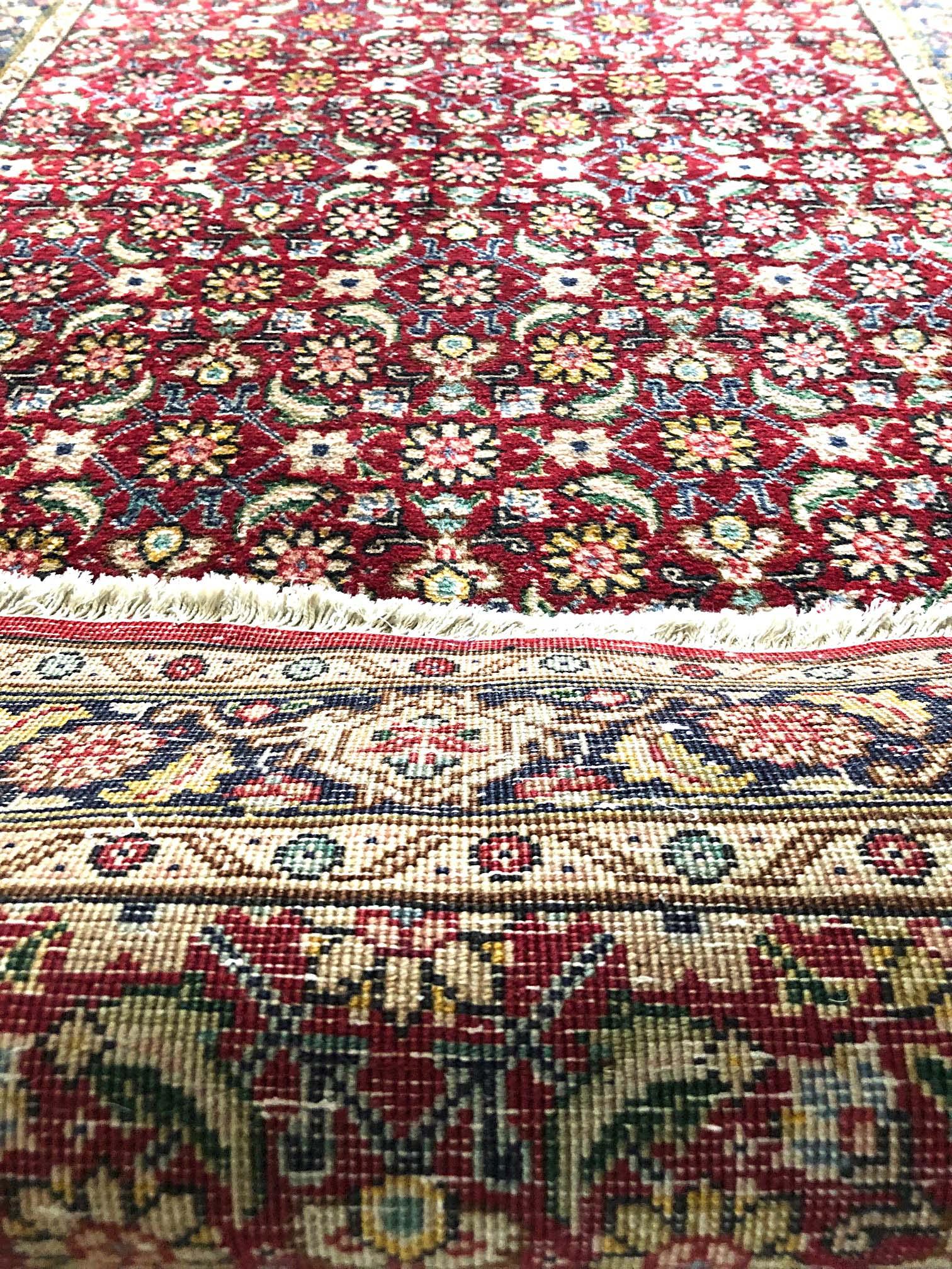 This Persian Tabriz runner has wool pile and cotton foundation. The design is called Herati design, Herati rugs are quite well known among the different styles of Persian rugs. The base color is red and border is dark blue. The size is 2 feet 9
