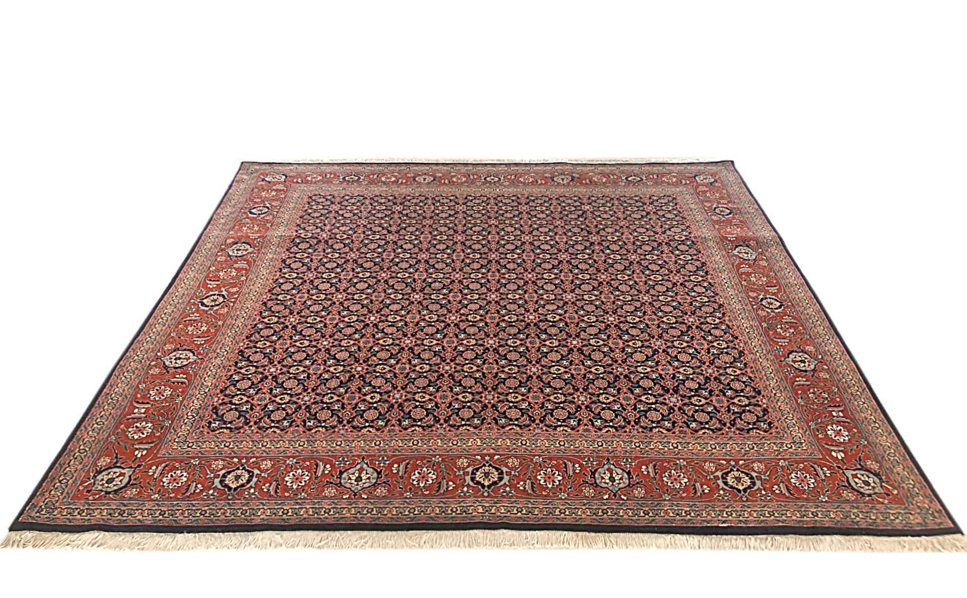 This authentic Persian Tabriz rug has wool and silk pile with cotton foundation. This rug features an all-over Herati design which is a very well-known design among Persian rugs. This piece has dark blue base color with rust border. The size is 6