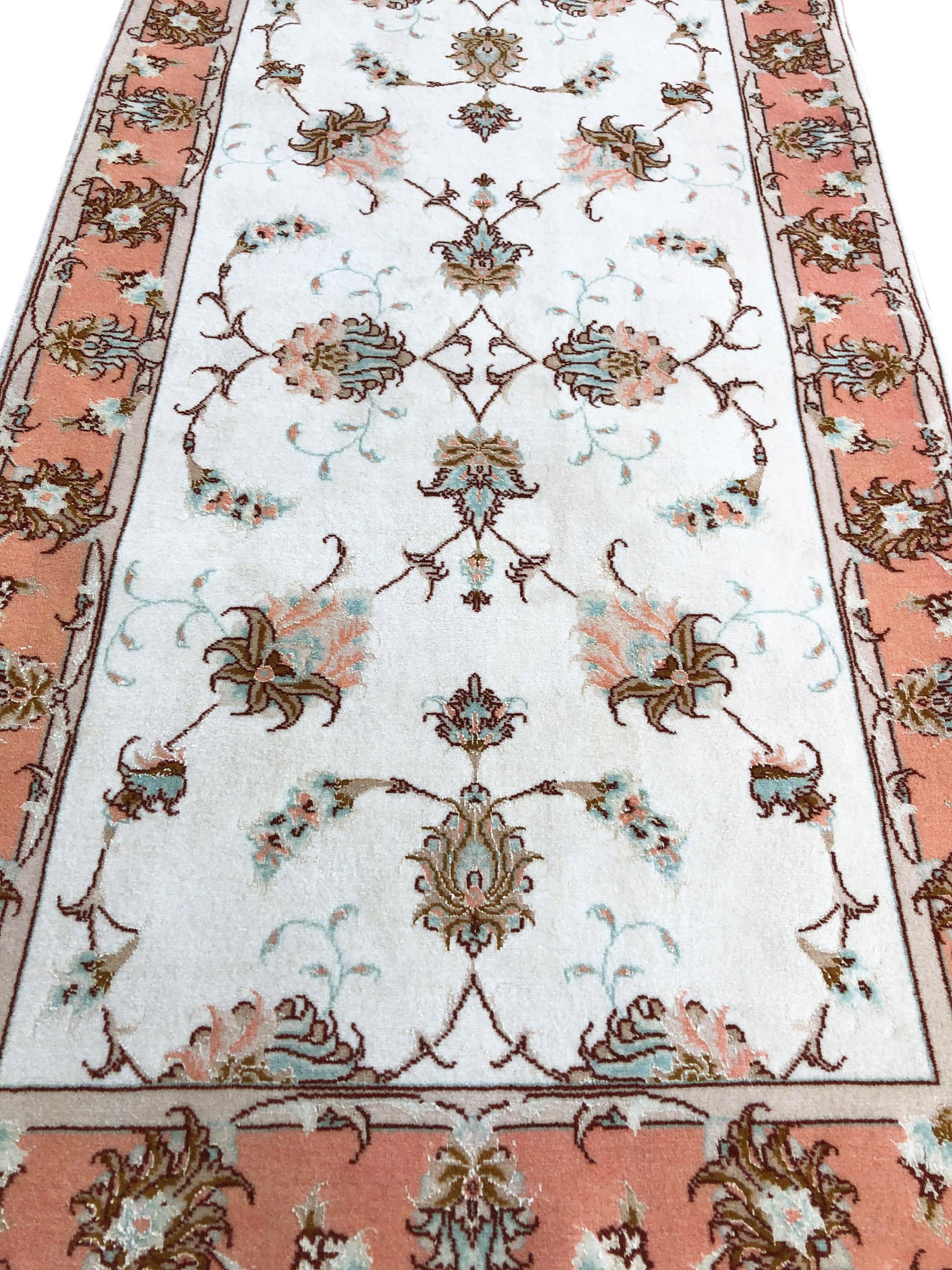 This rug is a hand knotted Persian Tabriz rug with a wool and silk pile on cotton foundation. Tabriz is one of the oldest rug weaving centers and makes a huge diversity of types of rugs. This rug features a semi-floral all-over pattern which has