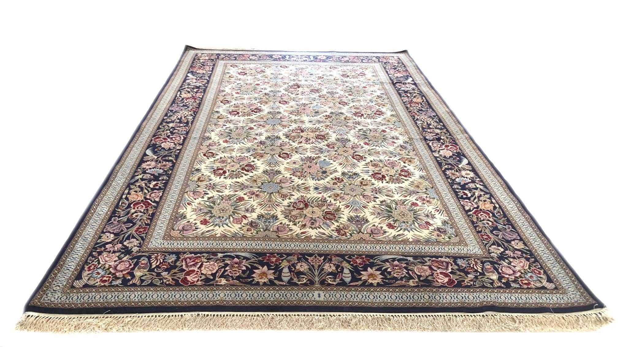 This authentic Persian Isfahan rug has wool and silk pile on silk foundation and has an excellent condition. The color combination and design in this rug is absolutely outstanding. The base color is cream and the border is dark blue. This rug has