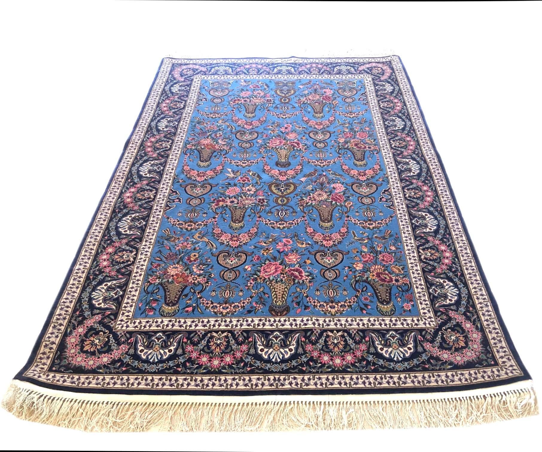 This authentic Persian Isfahan rug has wool and silk pile on silk foundation with an excellent condition. The color combination and design (A-symmetrical flower vase design) in this rug is absolutely unique. This rug has signed by Hassan Rahimi who