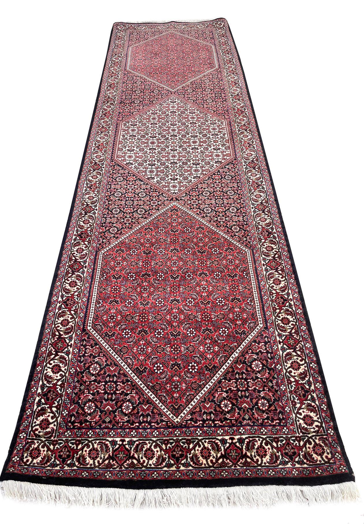 This Authentic beautiful Bijar runner has wool pile and cotton foundation with Herati fish design. It is made using high-quality wool, and the knots are beaten down using a heavy metal comb to give a tight, dirt-resistant pile. This stunning Persian
