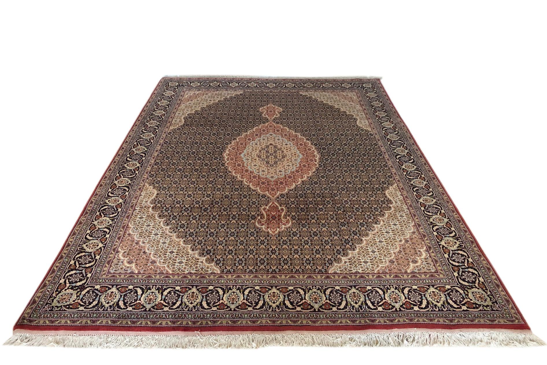 This piece is a handmade Persian Bijar rug. The pile is wool and silk with cotton foundation. This beautiful rug is made using high-quality wool, and the knots are beaten down using a heavy metal comb to give a tight, dirt-resistant pile. The Bijar