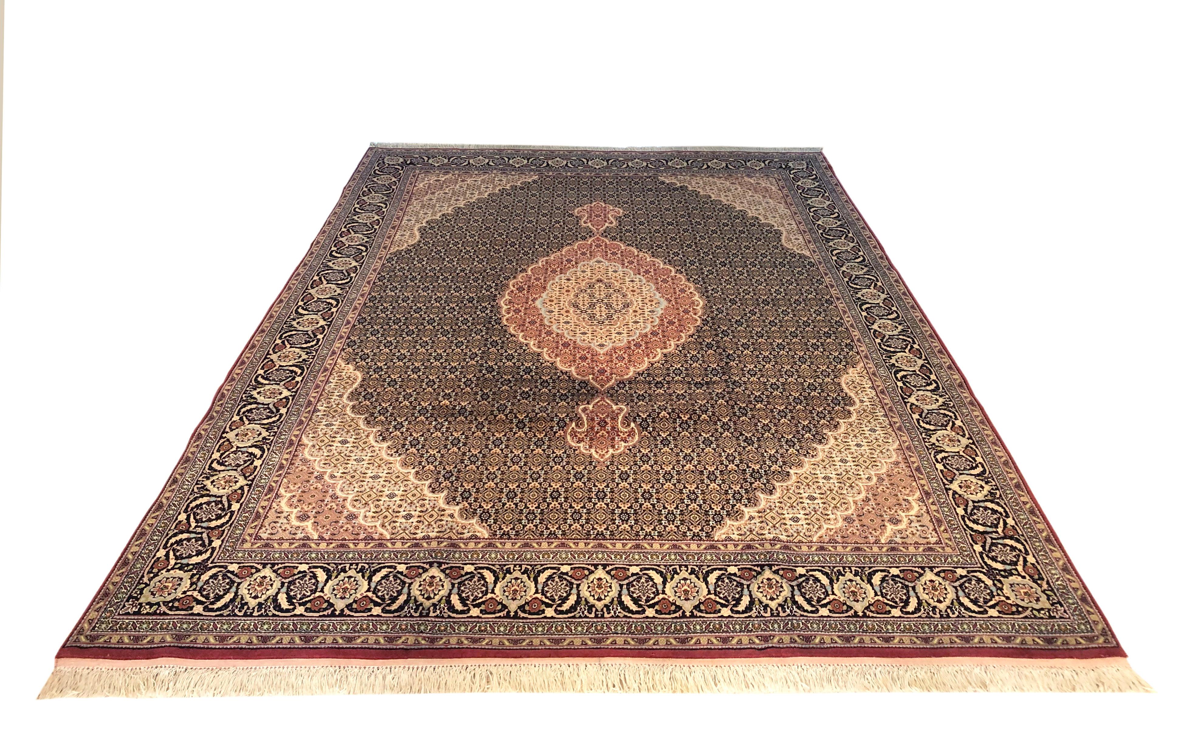 This piece is a handmade Persian Bijar rug. The pile is wool and silk with cotton foundation. This beautiful rug is made using high-quality wool, and the knots are beaten down using a heavy metal comb to give a tight, dirt-resistant pile. The Bijar