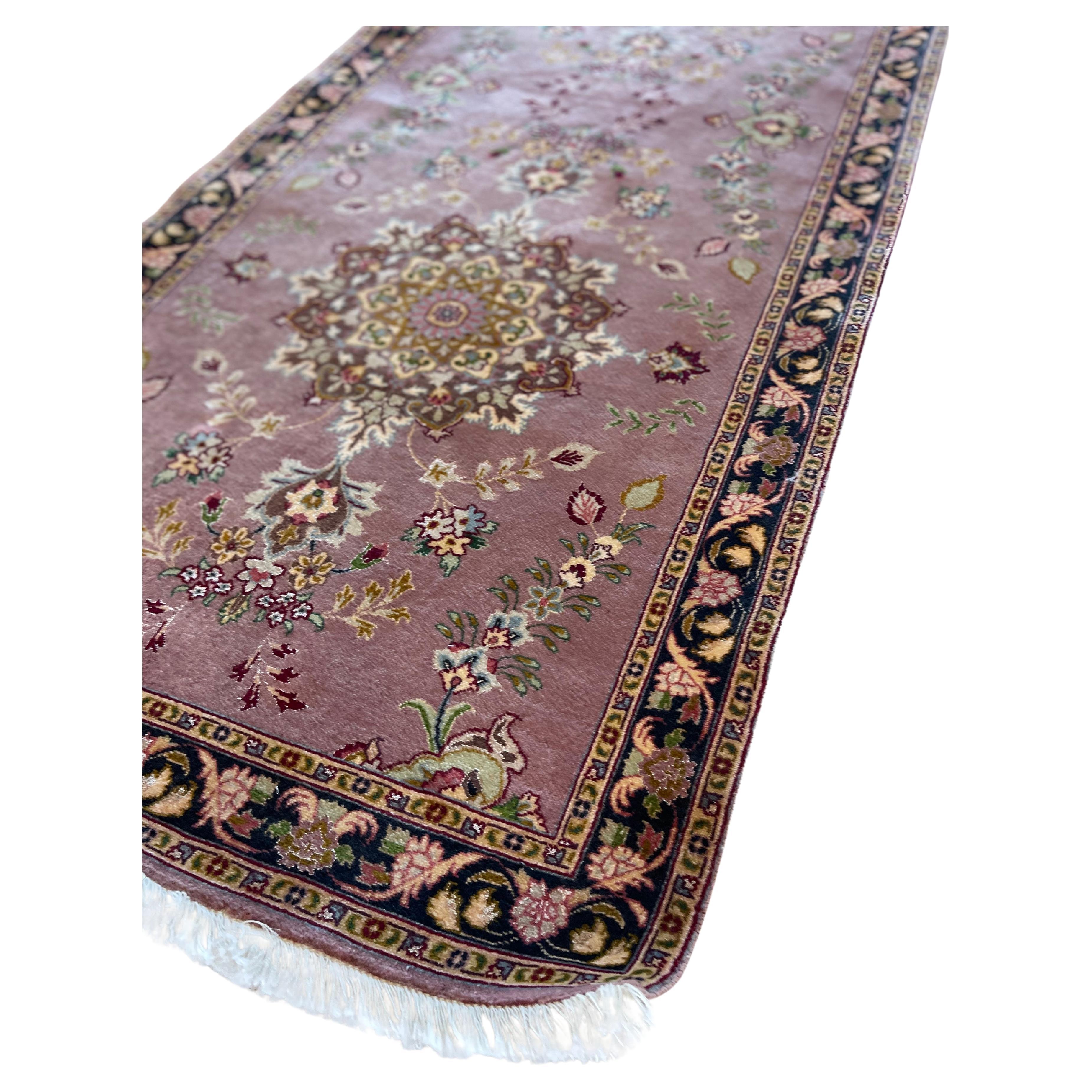 Introducing a stunning hand knotted Persian Tabriz runner that epitomizes quality craftsmanship and timeless beauty. Featuring an enchanting medallion floral design, this rug captivates with its unique blend of colors and patterns. The combination