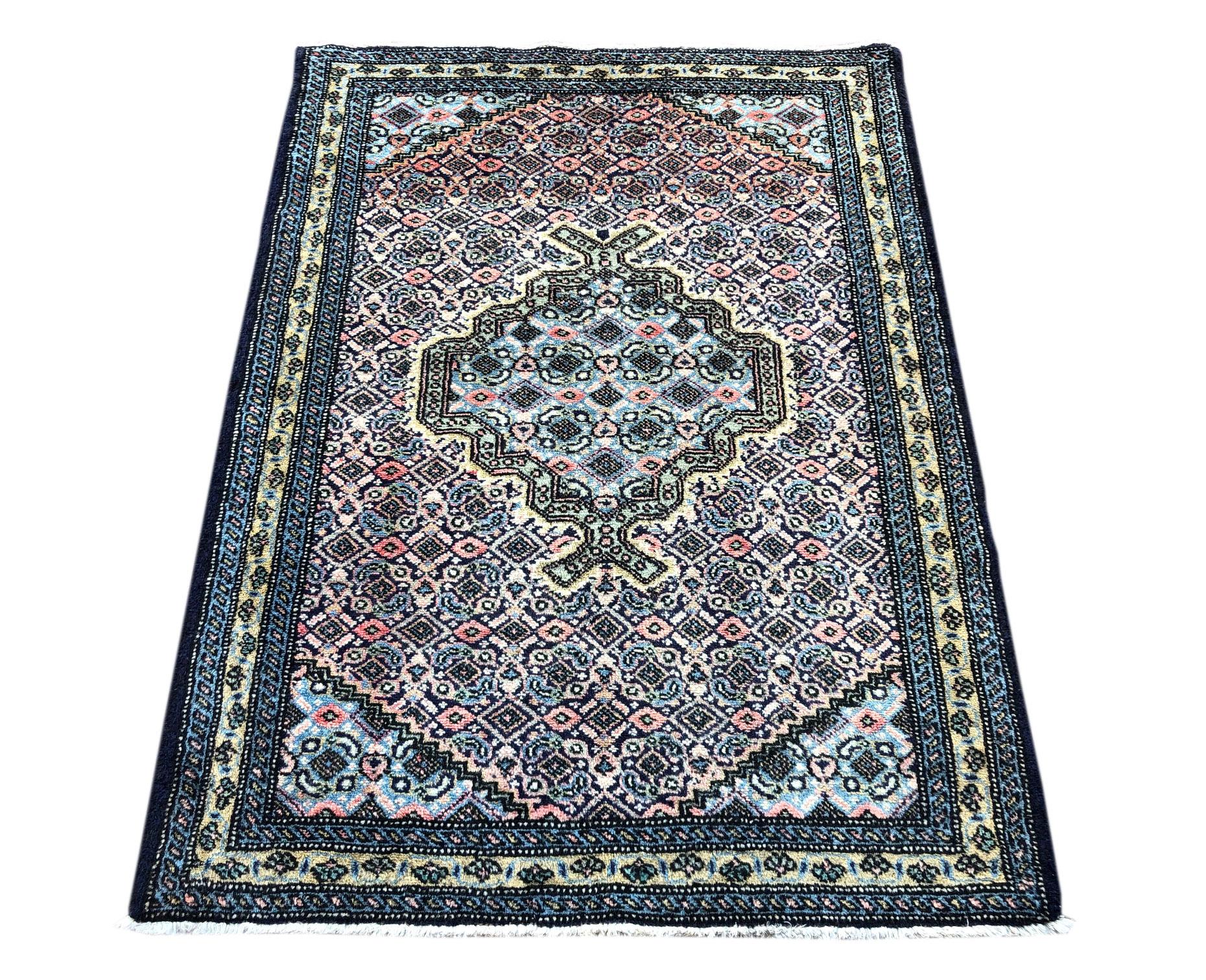 This rug is knotted in the province of Azarbayjan in north-west of Iran. The design is fish and diamond with medallion. The pile is wool with cotton foundation. The size is 2 feet 6 inches wide by 3 feet 6 inches tall. The design and color