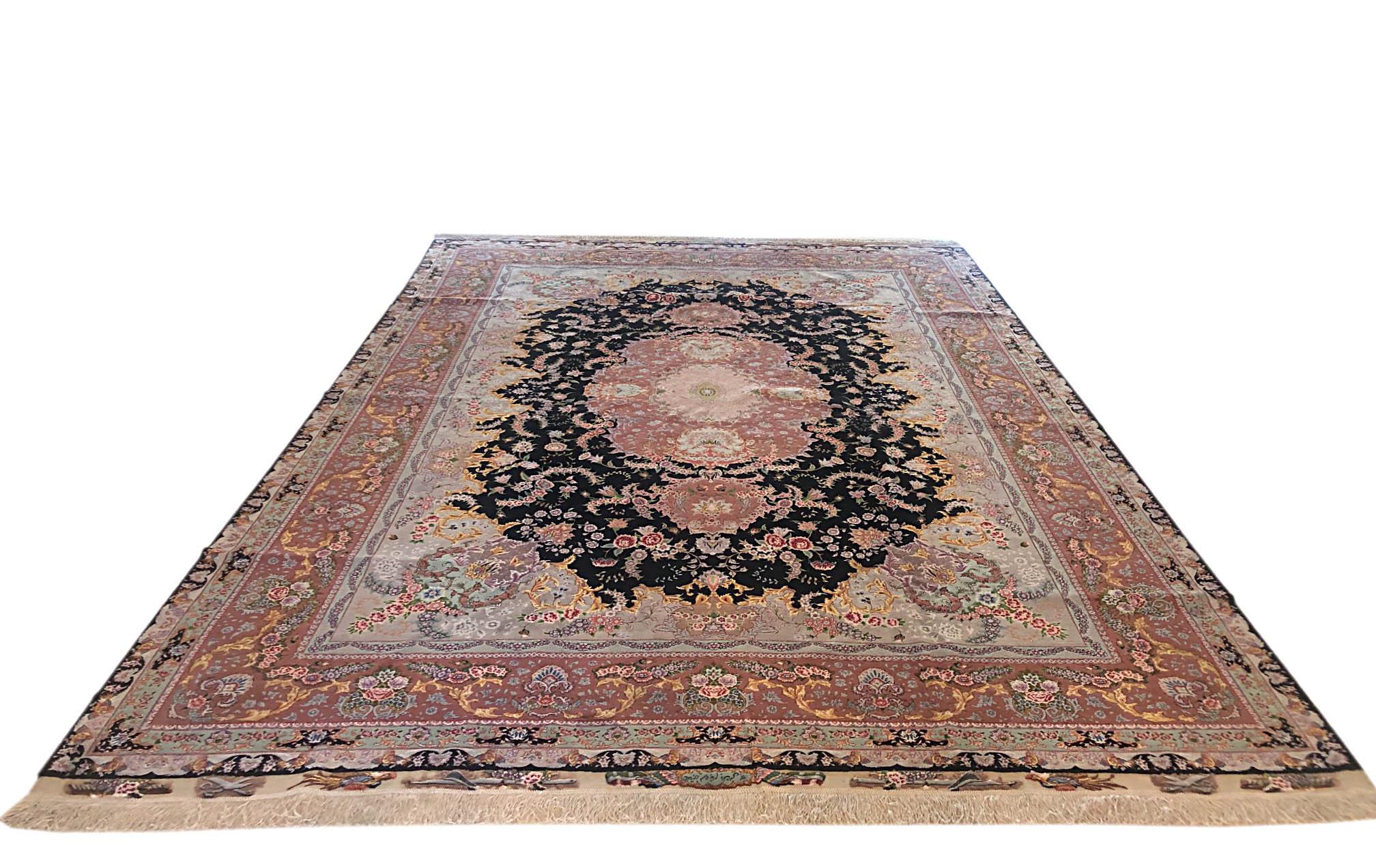 This rug is a hand knotted master piece Persian Tabriz rug with an excellent quality. This rug features a floral medallion pattern designed by famous designer in Tabriz called Benam. The pile is wool and silk with silk foundation. The size is 8 feet
