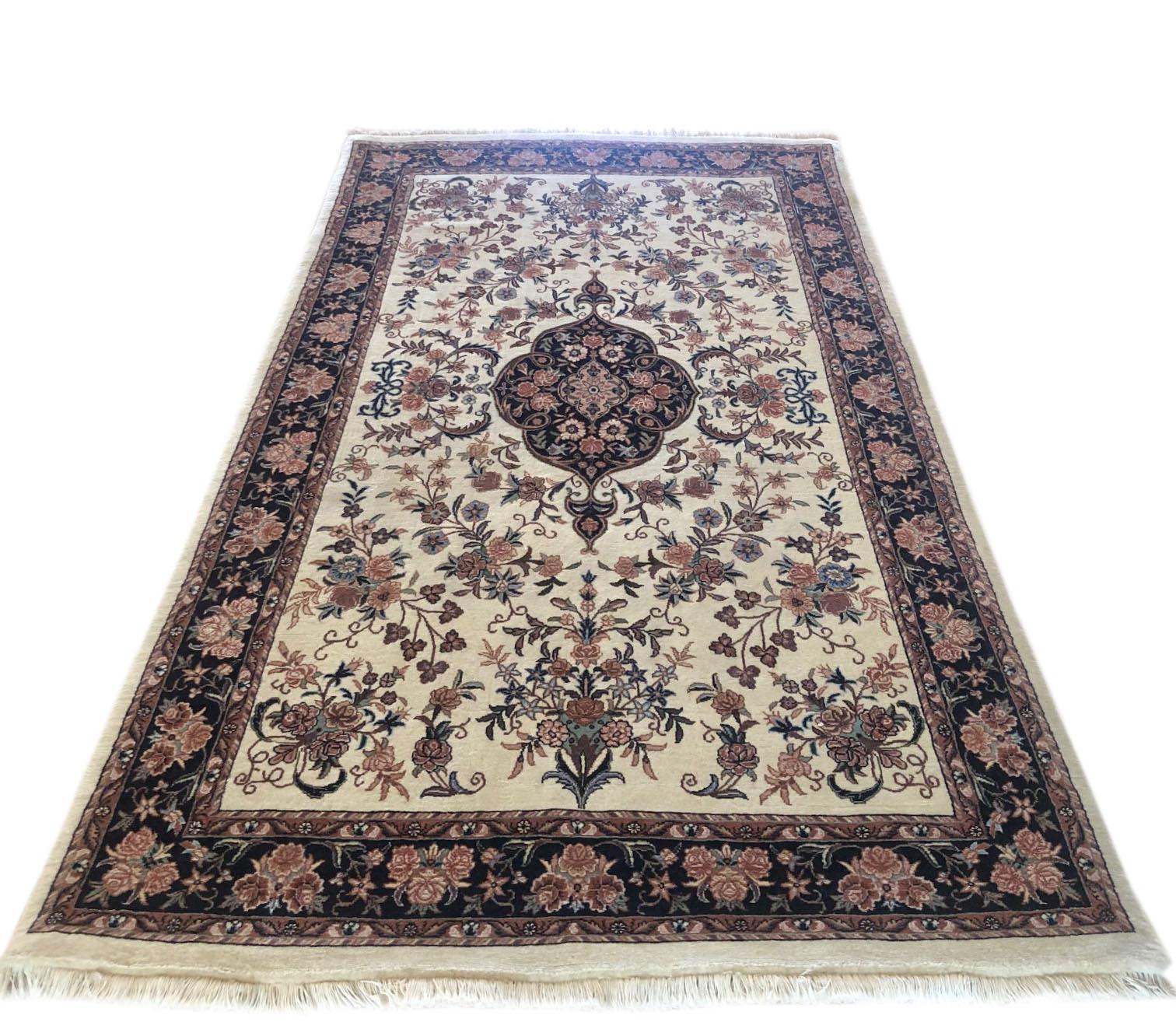 This piece is a handmade Persian Bijar rug. The pile is wool and silk with cotton foundation. The base color is cream, with black border. Bijar rugs are well-known for their craftsmanship and design. The heavy wool foundation makes this rug very