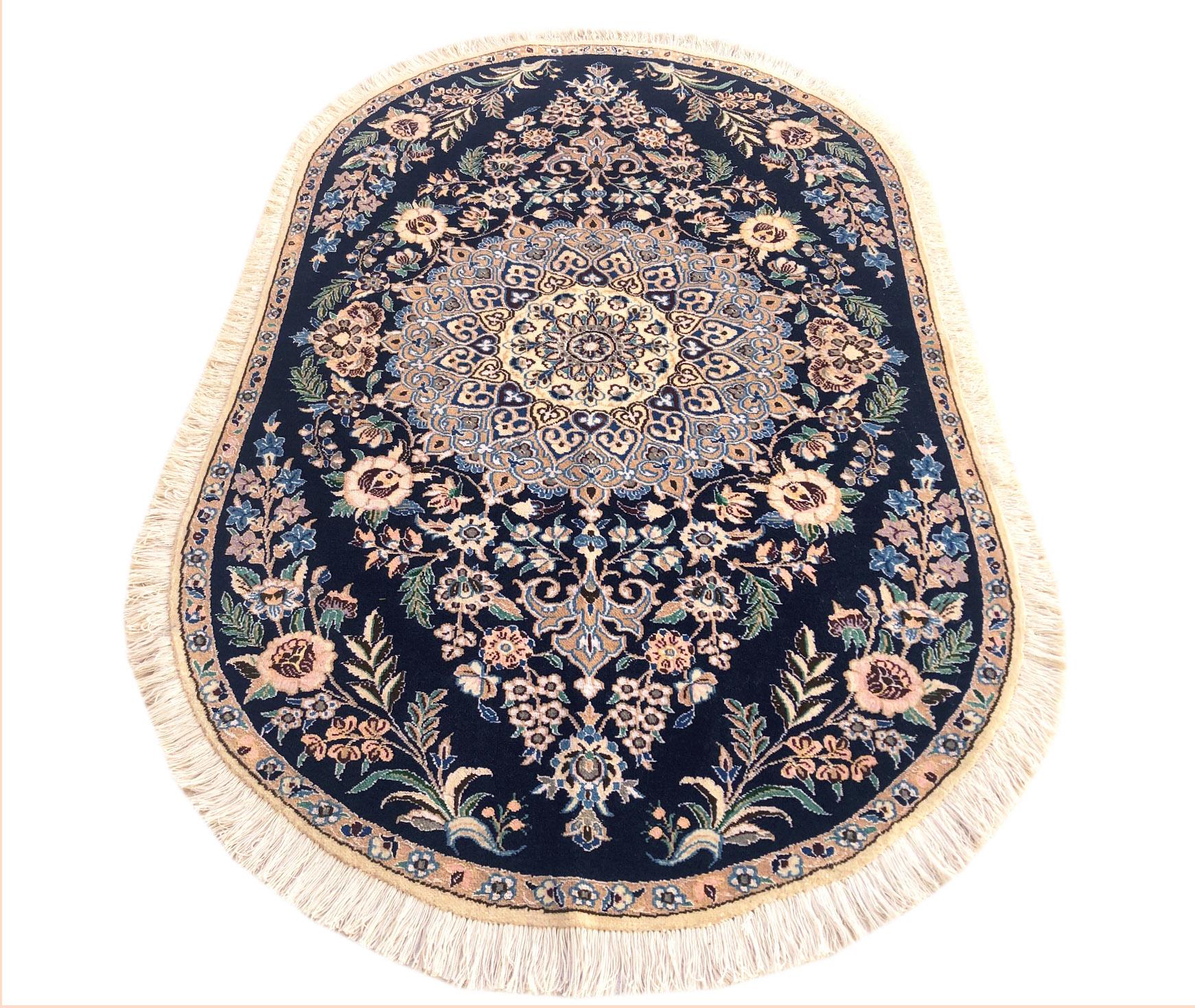 This authentic Persian round handmade Nain (9 LA) rug has wool and silk pile with cotton foundation. Nain is a city in Iran that is well known for producing fine handmade rug. This rug has diamond medallion floral design. The base and border colors