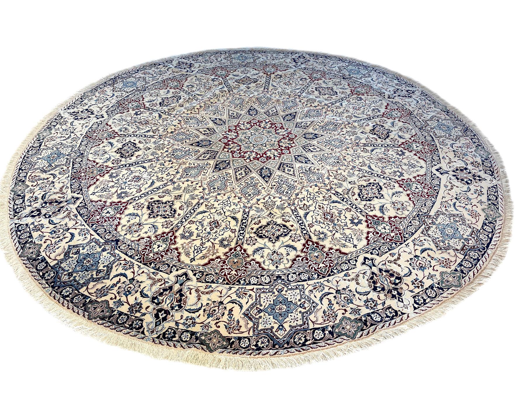 This authentic Persian round hand-made Nain 9 LAA ( rug has high quality wool and silk pile with cotton foundation. The silk highlights the detail in the design. Nain is a city in Iran that is well known for producing fine handmade rug. This rug has