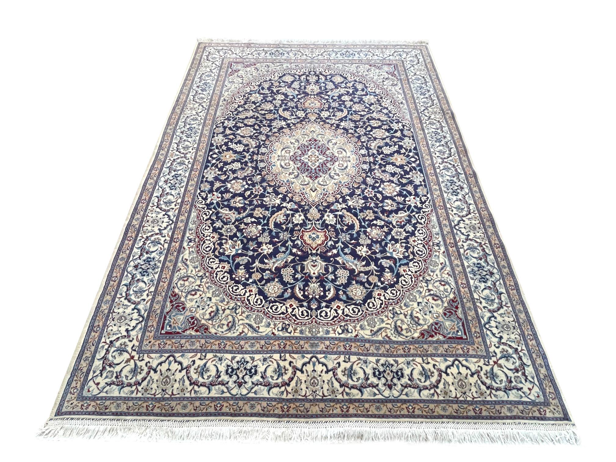 Featuring this authentic Persian hand-made Nain 9 La with high quality wool and silk pile with cotton foundation, which means this Nain 9 La has a very good quality that is going to be a great addition to your room. Nain is a city in Iran that is
