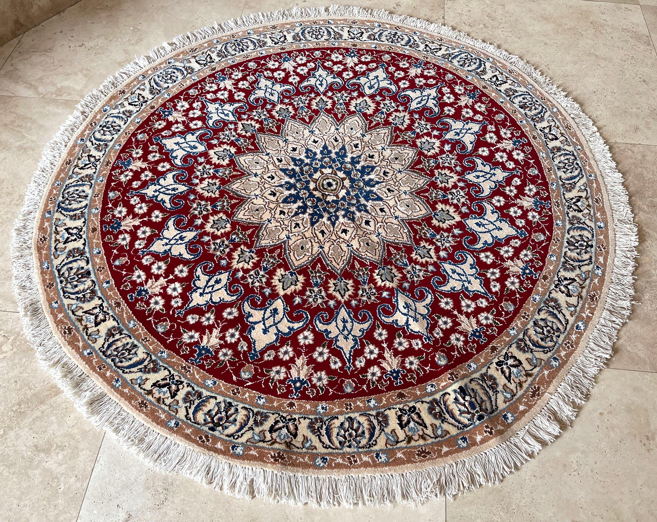 Persian hand knotted medallion floral cream red nain round rug 
This authentic Persian round hand-made Nain (9 LA) rug has wool and silk pile with cotton foundation. Nain is a city in Iran that is well known for producing fine handmade rug. This