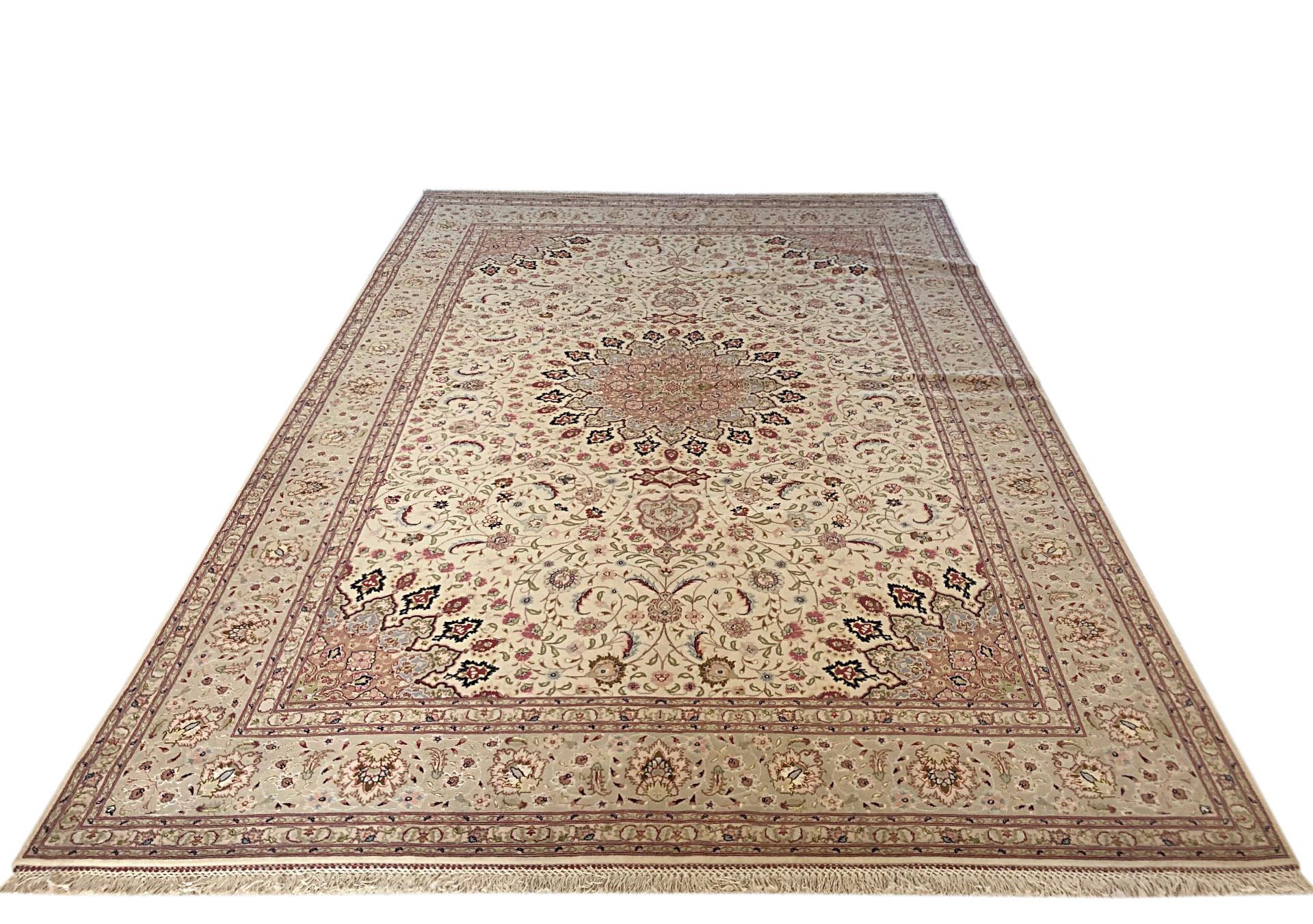 This is a hand knotted Persian Tabriz rug with a floral medallion design (Shahsavarpour Design). The pile is wool and silk with silk foundation. The size is 6 feet 6 inches wide by feet 9 feet 11 inches tall. This rug is a brand new rug. The design