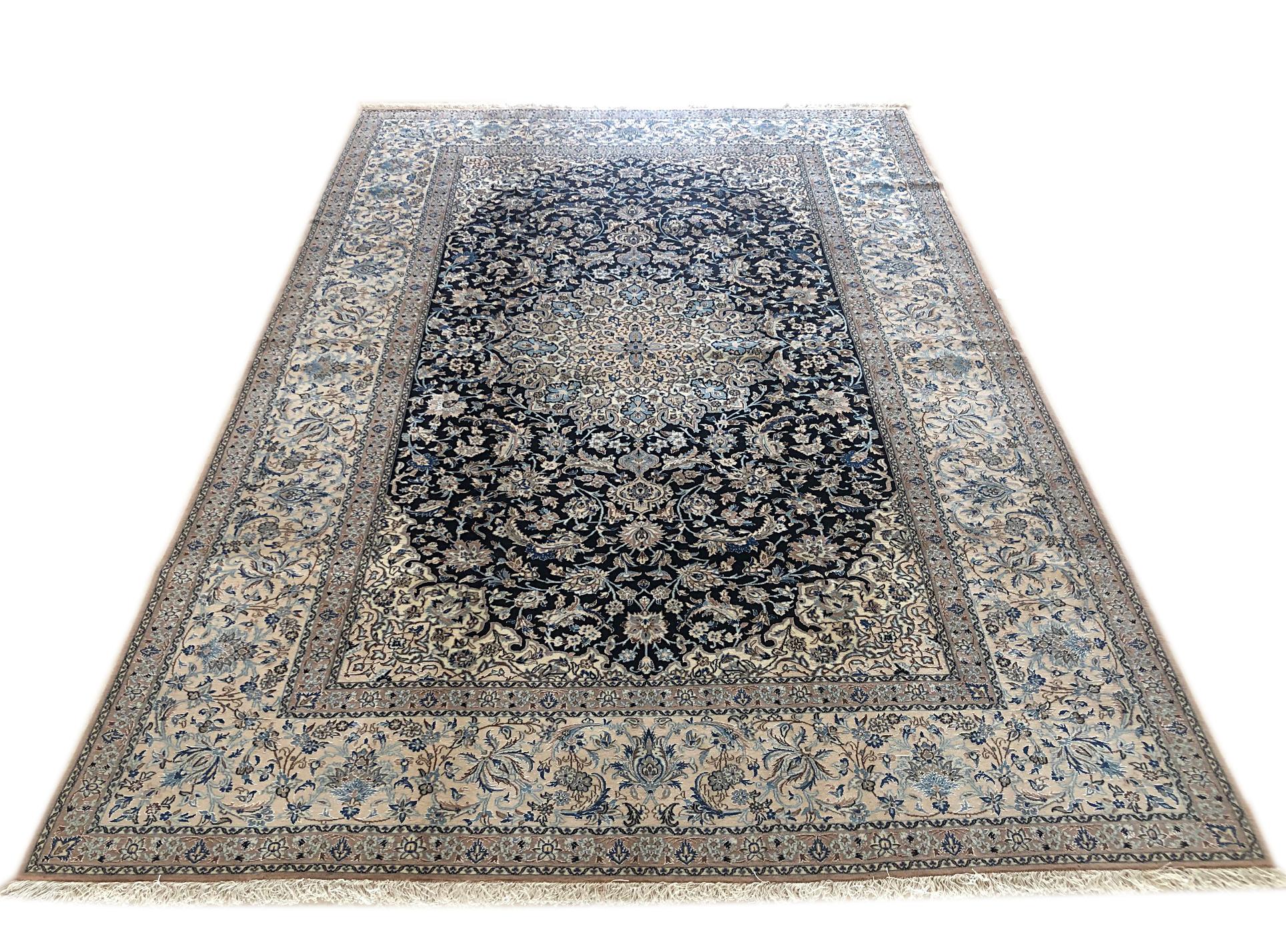 This authentic Persian hand-made Nain (9 LA) rug has wool and silk pile with cotton foundation. Nain is a city in Iran that is well known for producing fine handmade rug. Nain rugs have a high reputation and are very popular. This beautiful rug has