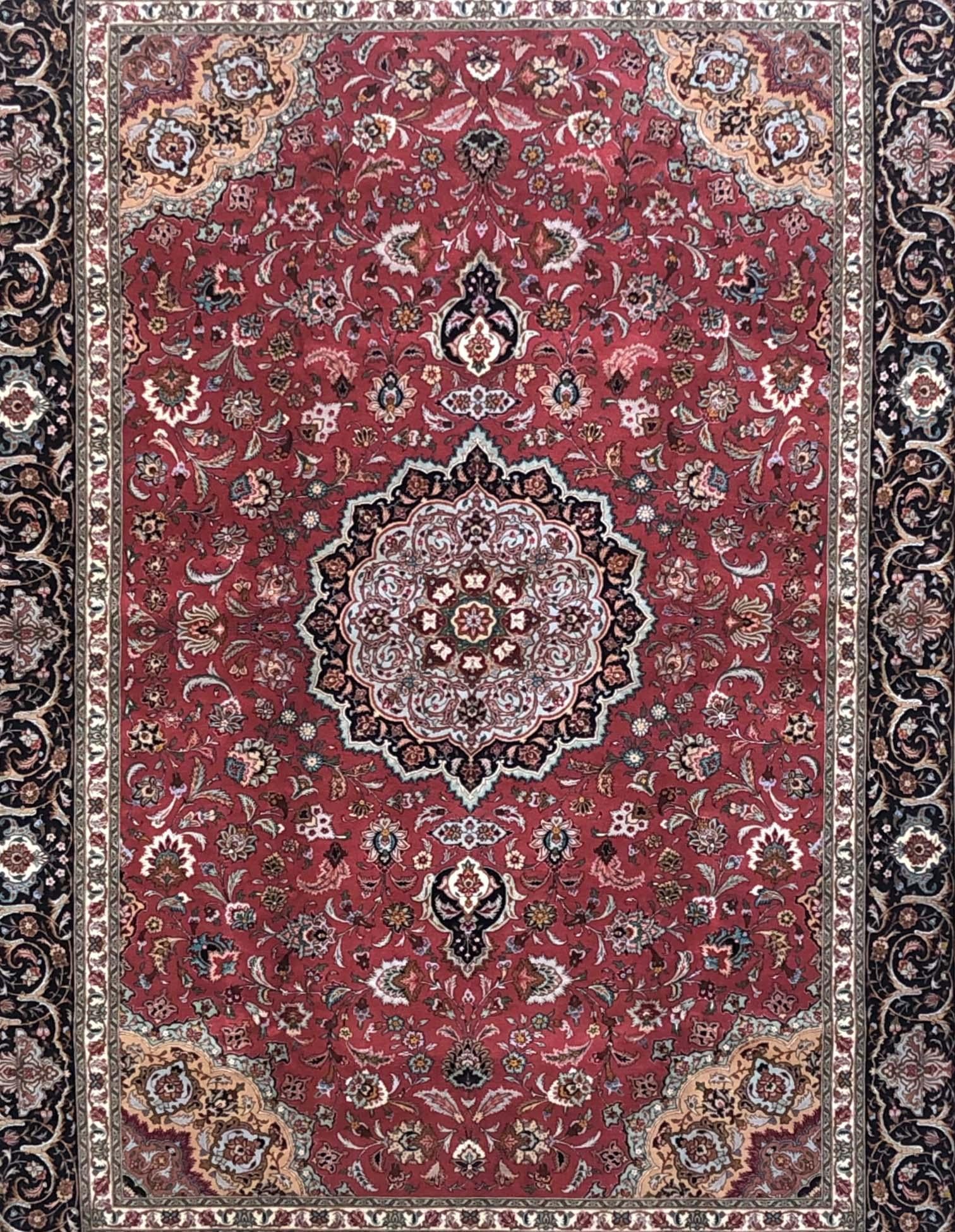 This authentic Persian handmade rug has wool and silk pile with cotton foundation. This rug is from Tabriz and has Javad Ghalam design. This rug has red base color with black border color. This is a brand new rug. The size is 6 feet 7 inches by 9