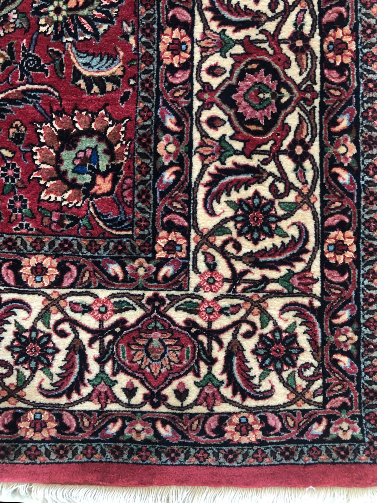 This piece is a handmade Persian Bijar (Tokun) rug. The pile is wool and silk with cotton foundation. The base color is red, with cream border. This rug has highly detailed floral design which is called Golfarang. Bijar rugs are well-known for their