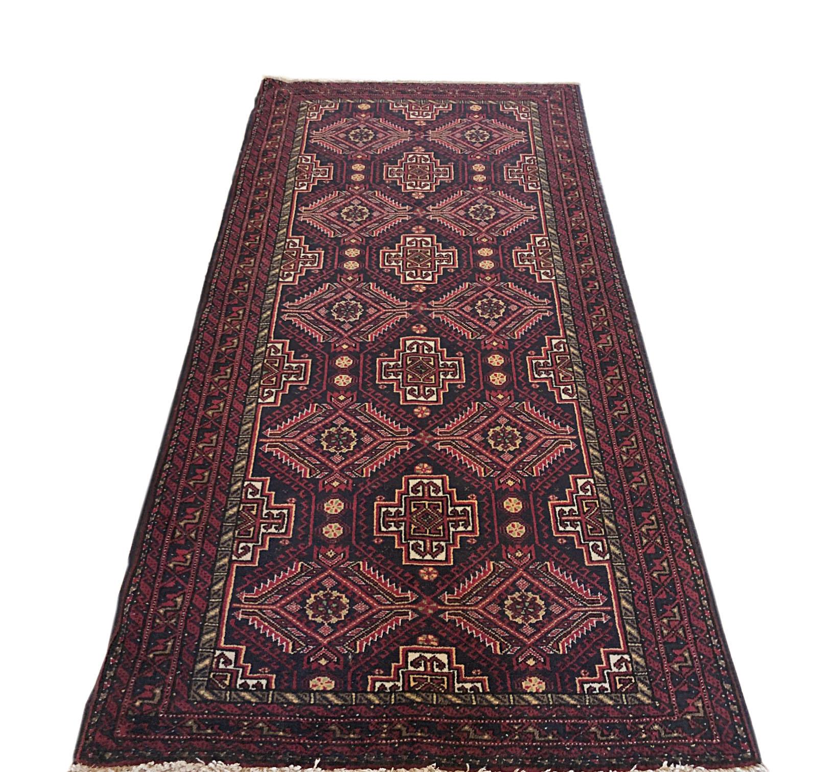 This beautiful Persian Baluchi rug has wool pile with cotton foundation. The size is 2 feet 9 inch by 5 feet 9 inches which can make any environment a bit more warm and cozy and is a perfect for filling up the gap of non-decorated area in your home