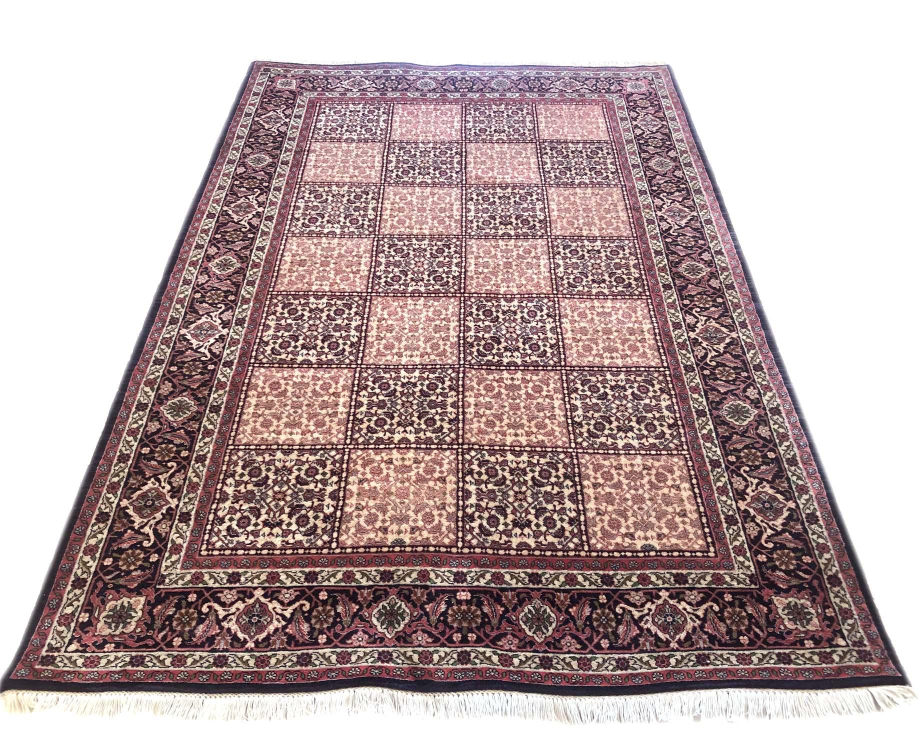This piece is a handmade Persian Bijar rug. This piece has wool and silk with cotton foundation. The base colors are red and cream, with black border. This rug has highly detailed design with unique panel design which is a unusual pattern in Bijar