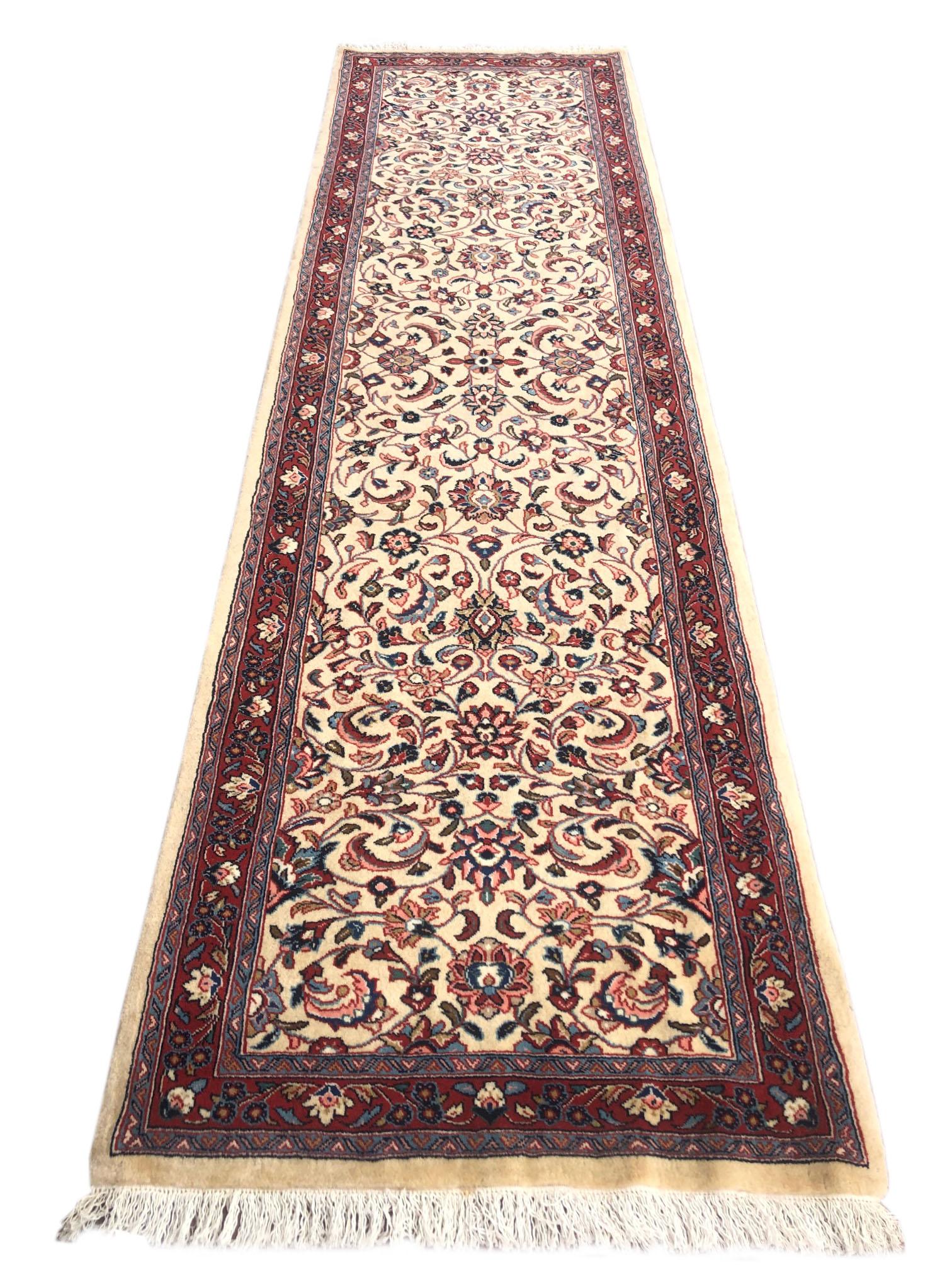 This runner is a hand knotted Sarouk rug with wool pile and cotton foundation. A Sarouk or Sarough rug is a type of Persian rug from Markazi Province in Iran and they are among fine selections among Persian rug market. The design is this beautiful