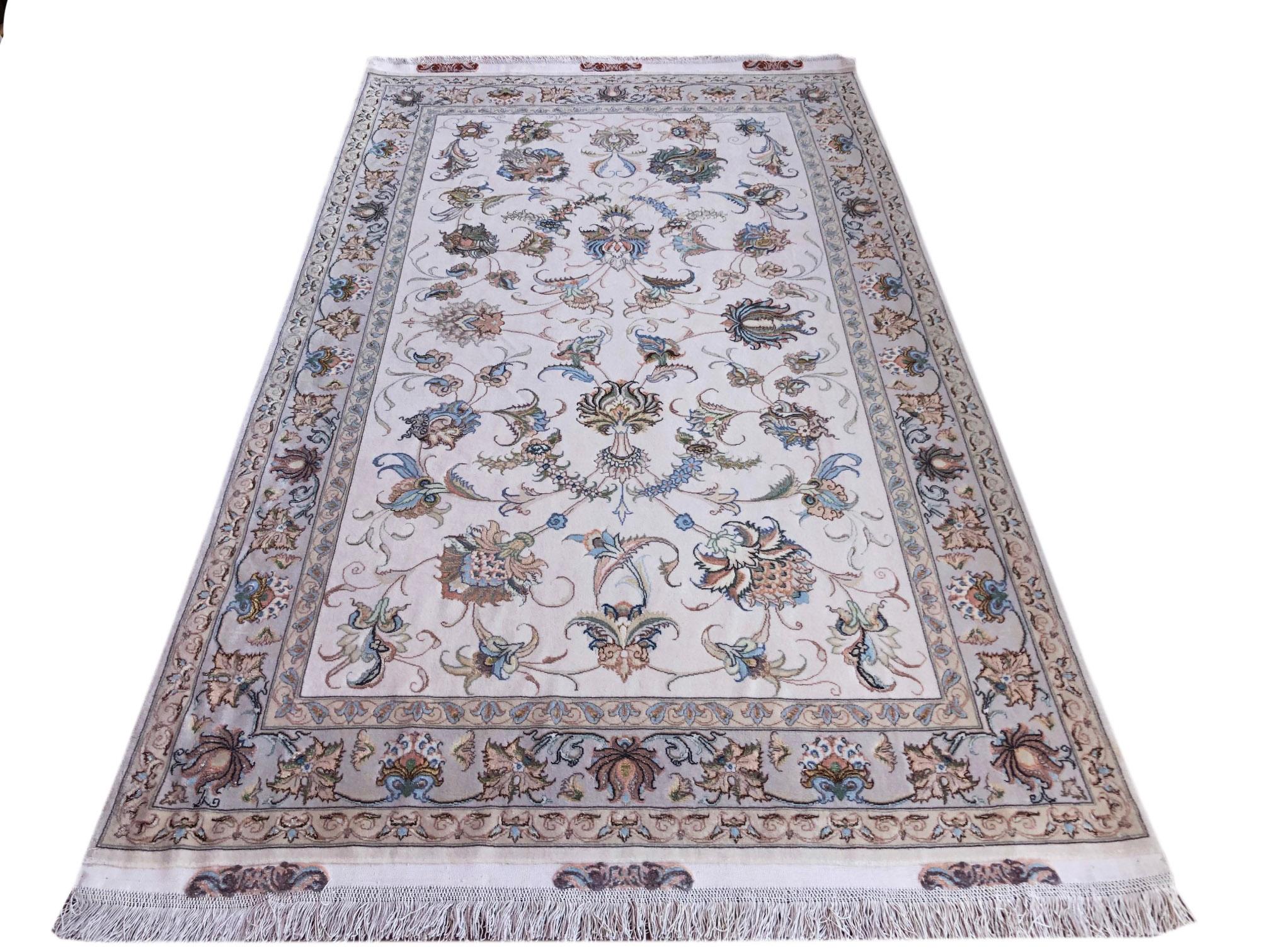 This rug is a hand knotted Persian Tabriz rug with a wool and silk pile on silk foundation. Tabriz is one of the oldest rug weaving centers and makes a huge diversity of types of rugs. This rug features a semi medallion with stunning floral