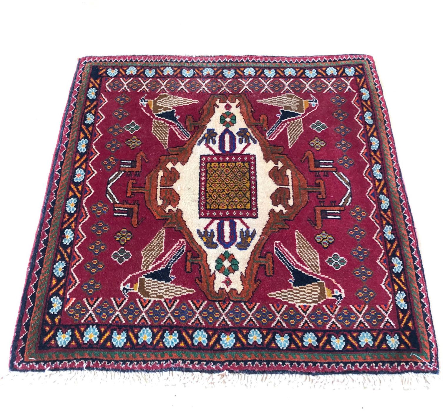 This authentic Persian Ghashghai rug is recognized by its joyful and bright color with geometric design. This rug has designed with tribal flowers and birds motifs. The size is 2 feet 3 inches wide by 2 feet 3 inches tall. The pile is wool and the