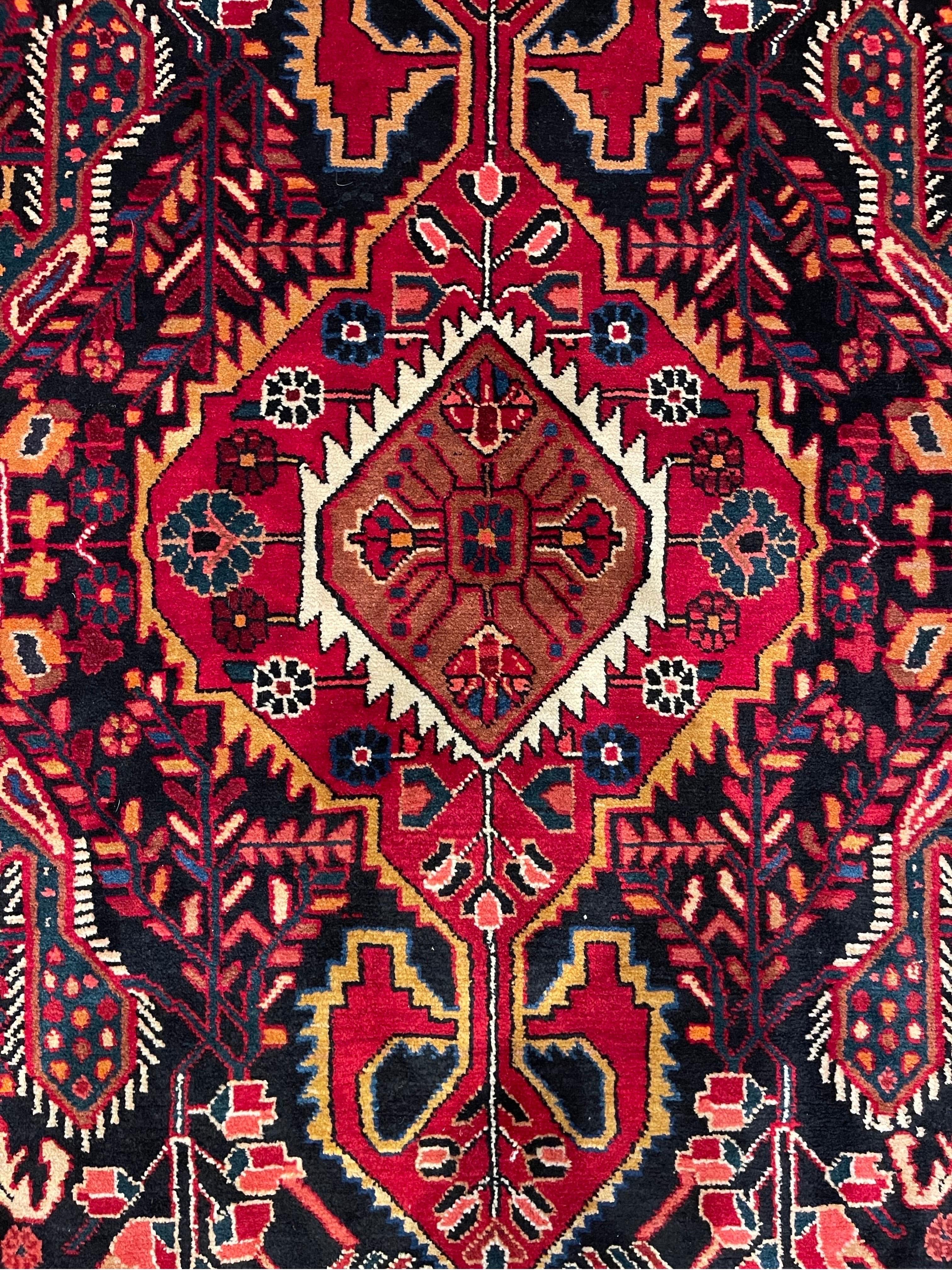 Bakhtiari rugs are known for being the brightest and most colorful of all nomadic rugs. Bakhtiari rugs are hand woven by the Bakhtiari tribe, one of the oldest and most well-known Persian rug industry.  This Piece has a geometric design with