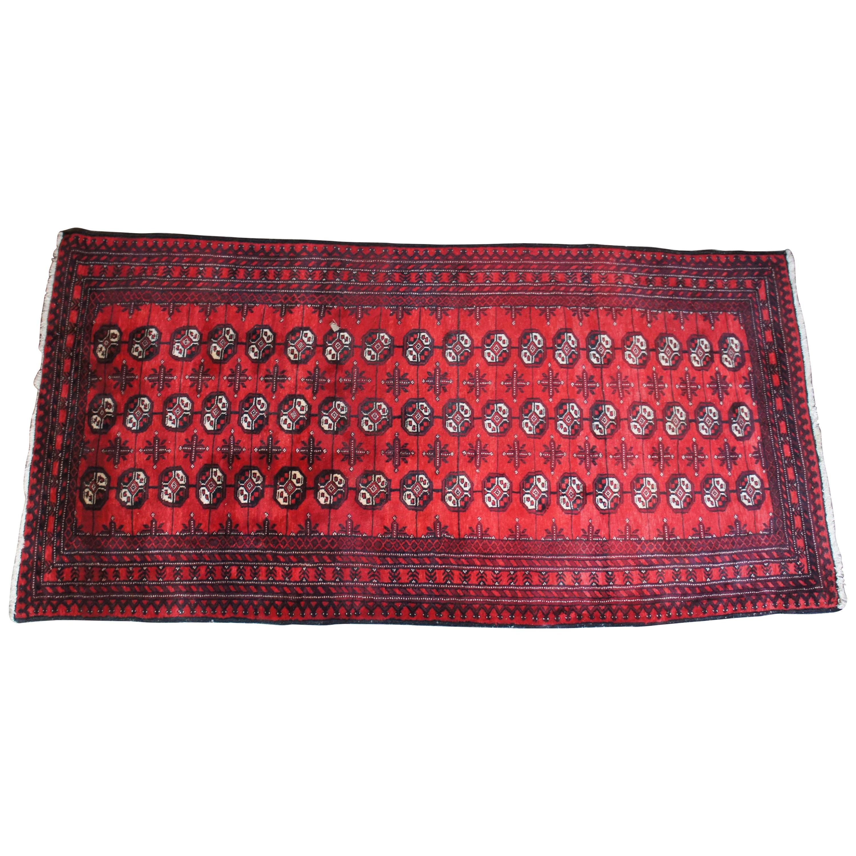 Vintage Persian hand knotted Royal Bokhara geometric wool and silk area rug, carpet or runner. Features a field of red with blacks and tans.
 