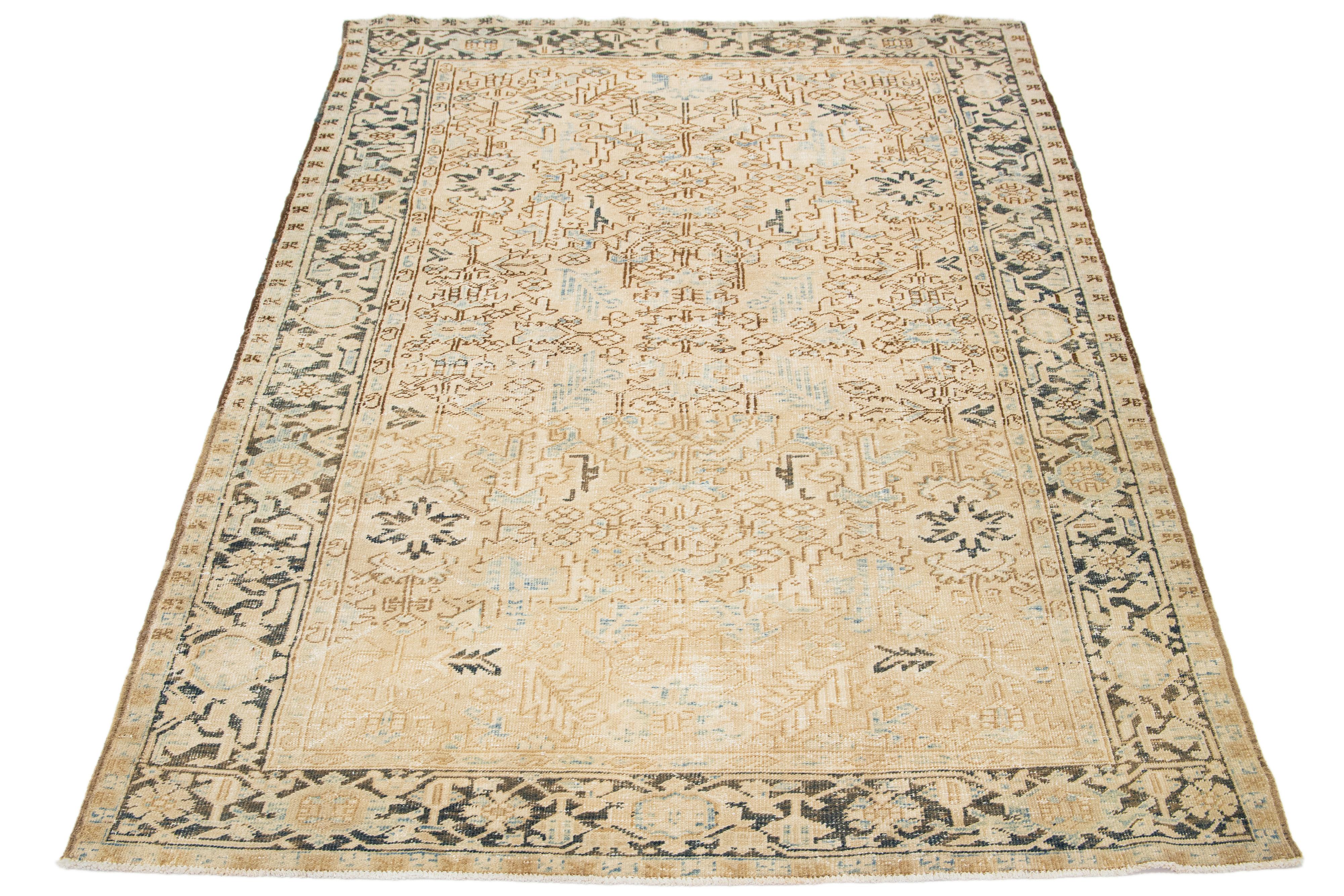 An antique Persian Heriz rug made of hand-knotted wool adorns a blue and brown all-over pattern on a beige field.

This rug measures 7'2' x 10'7