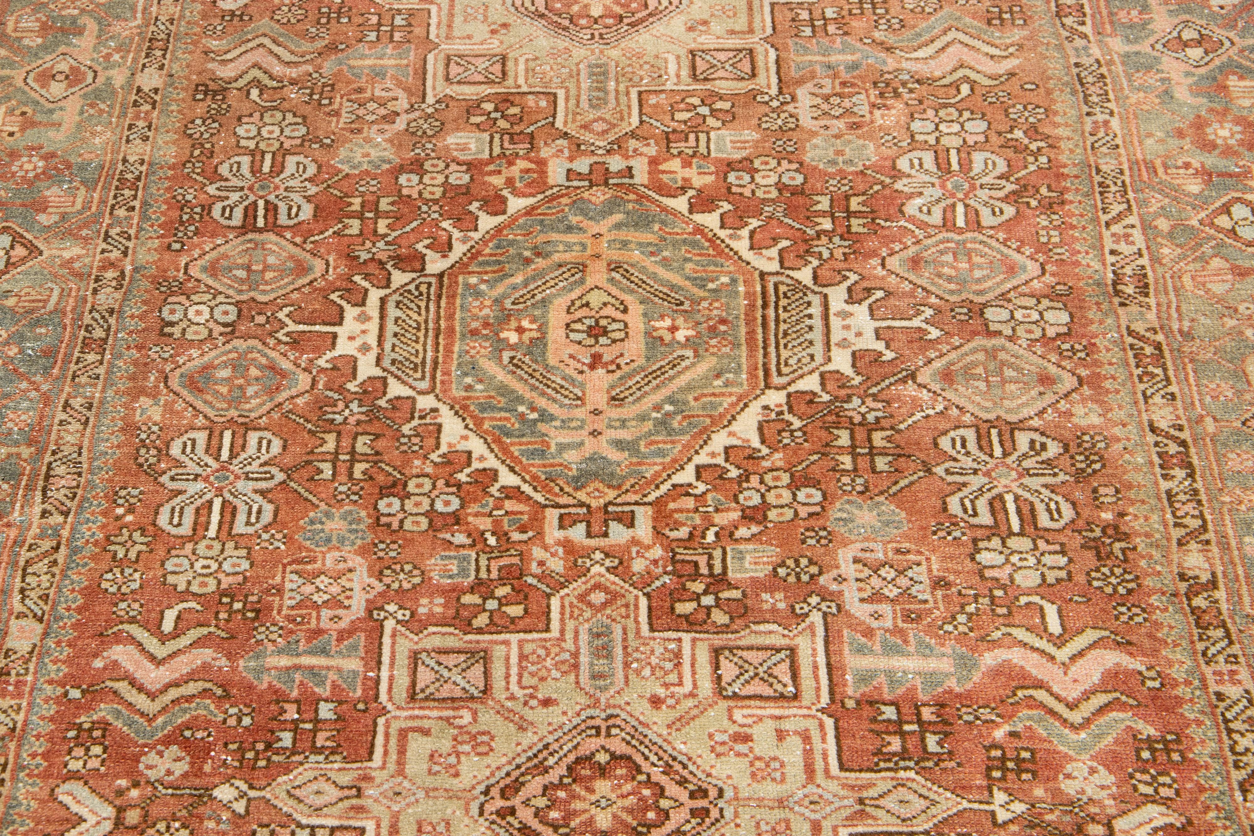 Early 20th Century Persian Heriz Antique Wool Rug In Rust Color Featuring a Tribal Pattern For Sale