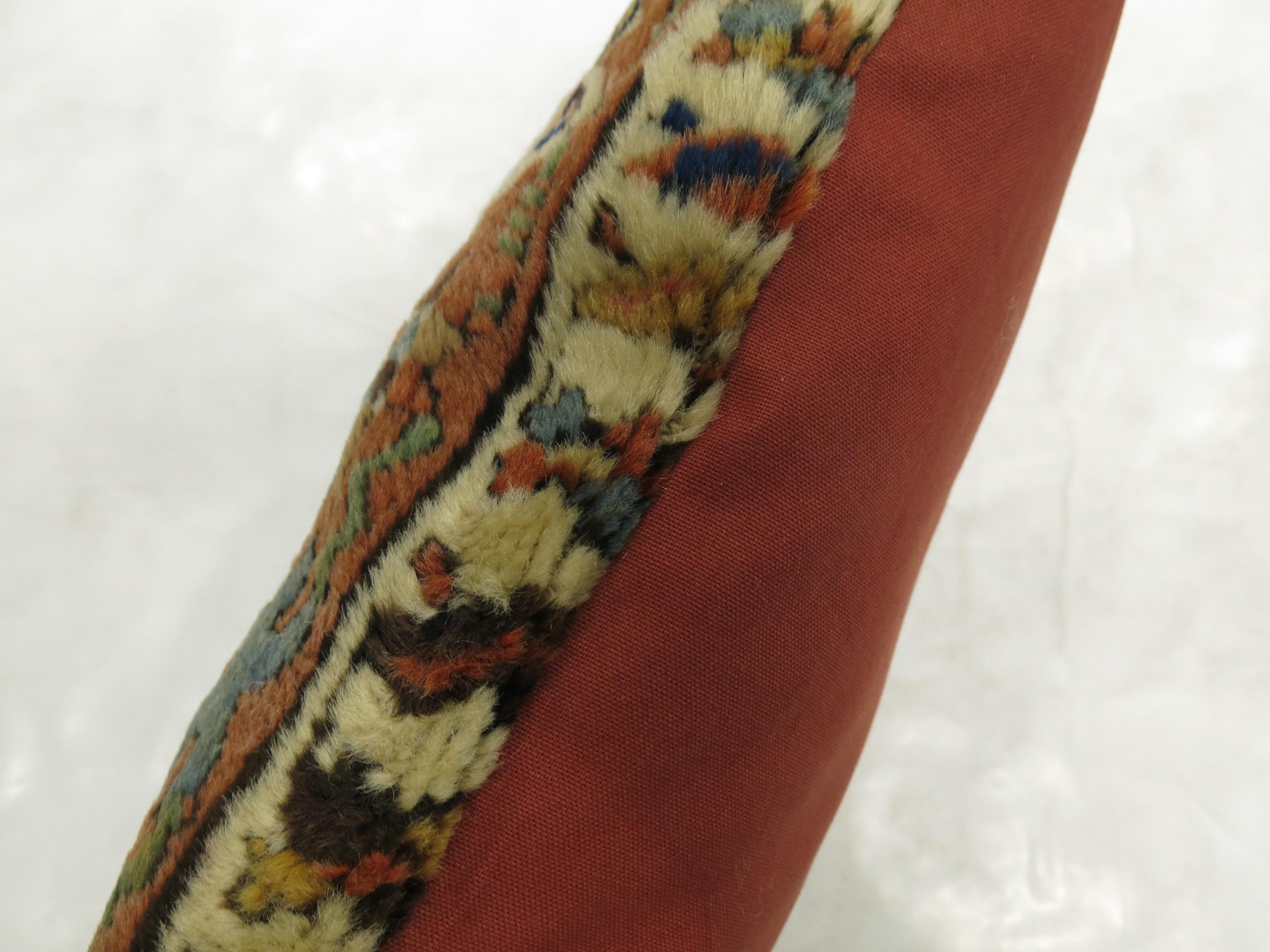 Large bolster size pillow made from an antique Persian Heriz rug.
