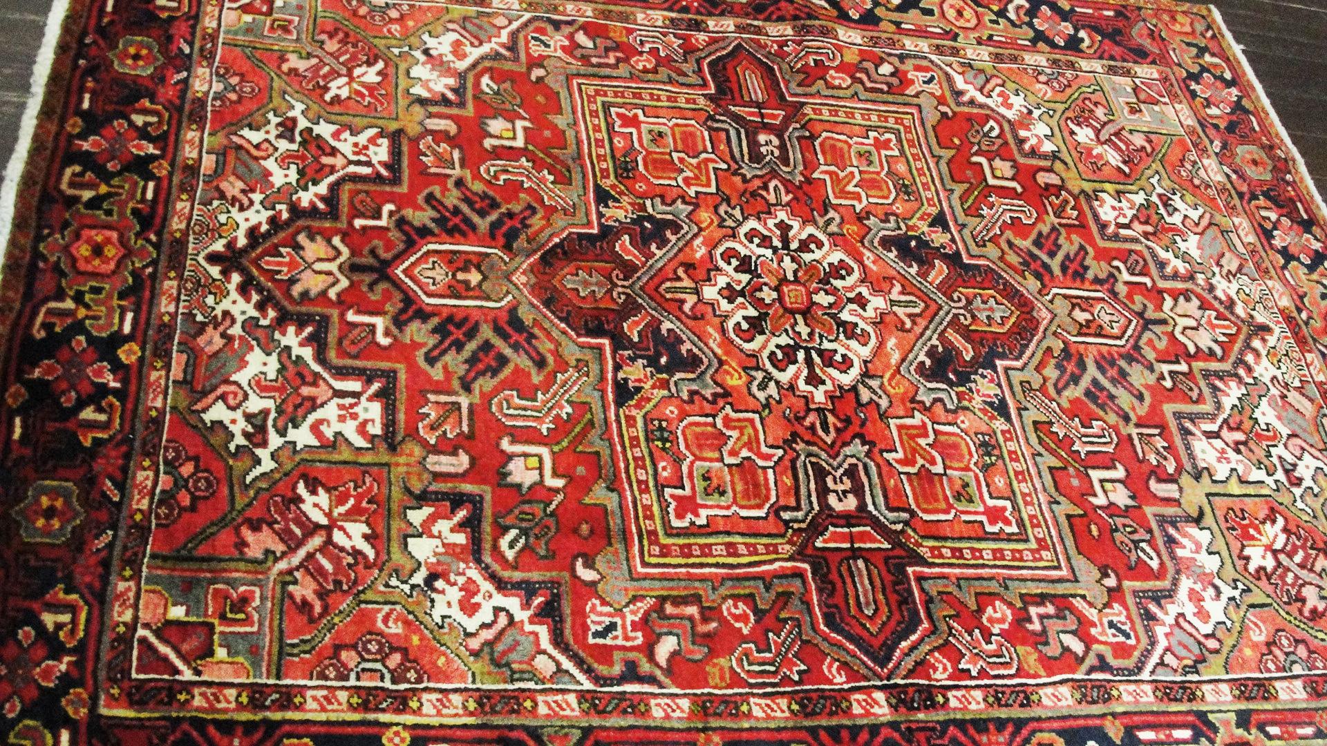Gorgeous Persian Heriz carpet with medallion design and red and blue background color. Heriz rugs are Persian rugs from the area of Heris, East Azerbaijan in northwest Iran, northeast of Tabriz. Such rugs are produced in the village of the same name