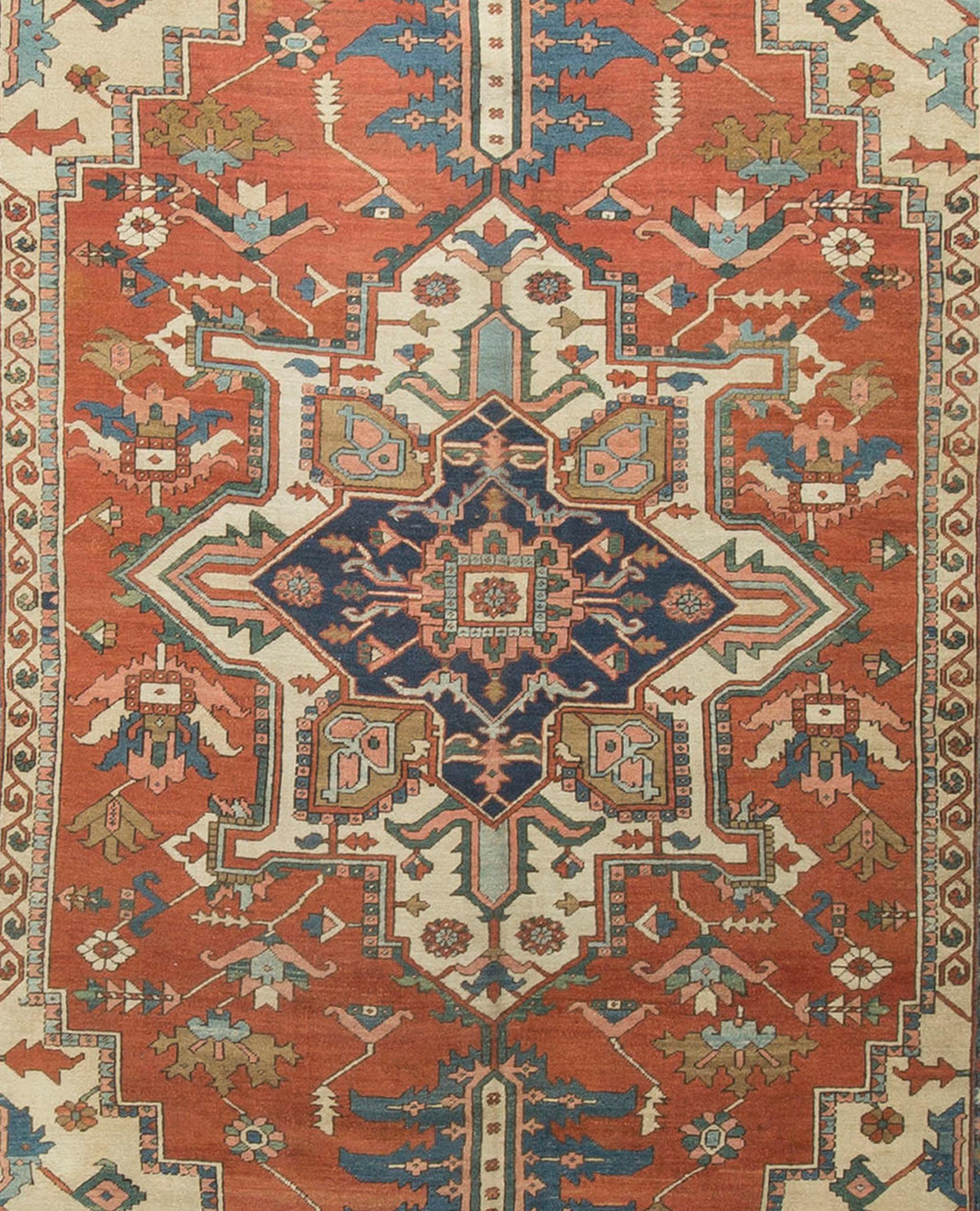 Persian Heriz Serapi Rug Carpet, circa 1890 9'1 x 13'7. The central blue and ivory medallion is so cleverly surrounded by a rust colored field with floral designs and the four corner spandrels in ivory help bring this piece to life. Enclosed by a
