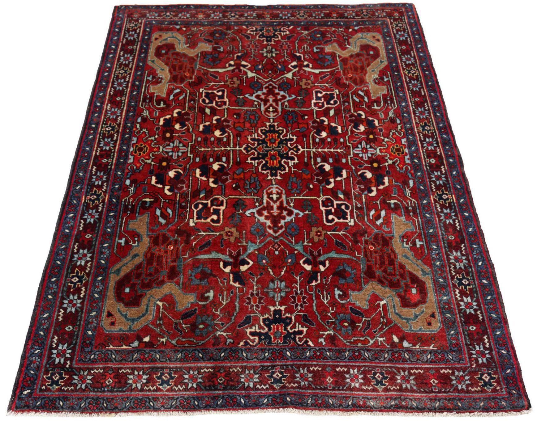 Entdecken Sie die Eleganz des persischen Heriz mit dem kleinen Teppich von CIRCA 1910. Dieses exklusive Design aus Wolle und Blau-Elfenbein-Rot ist perfekt, um Ihren Raum zu verschönern.