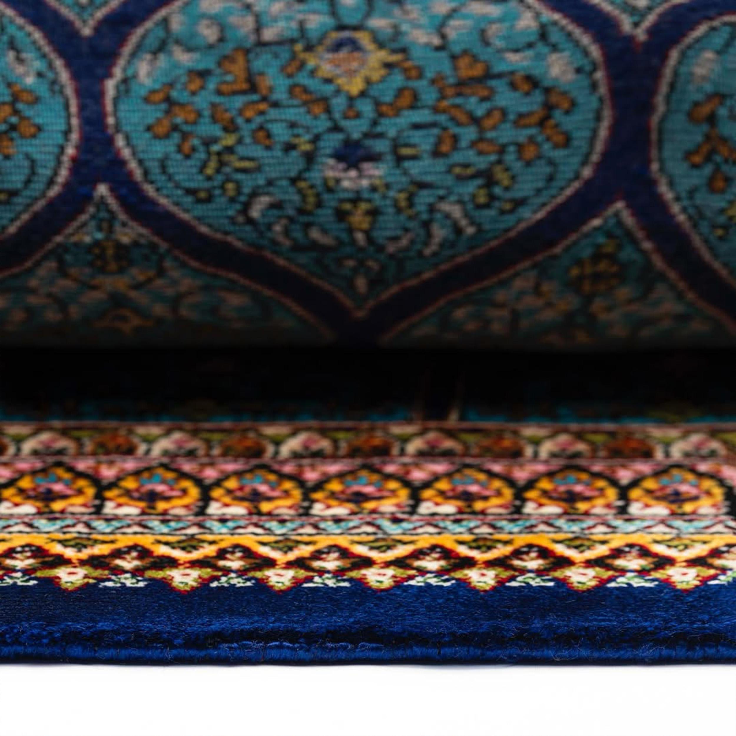 This exquisite Persian Isfahan style carpet showcases a radiant medallion design that draws the eye inward with mesmerizing precision. Hand-polished for a luxurious finish, its surface glows with deep lapis blue tones, intricately detailed with