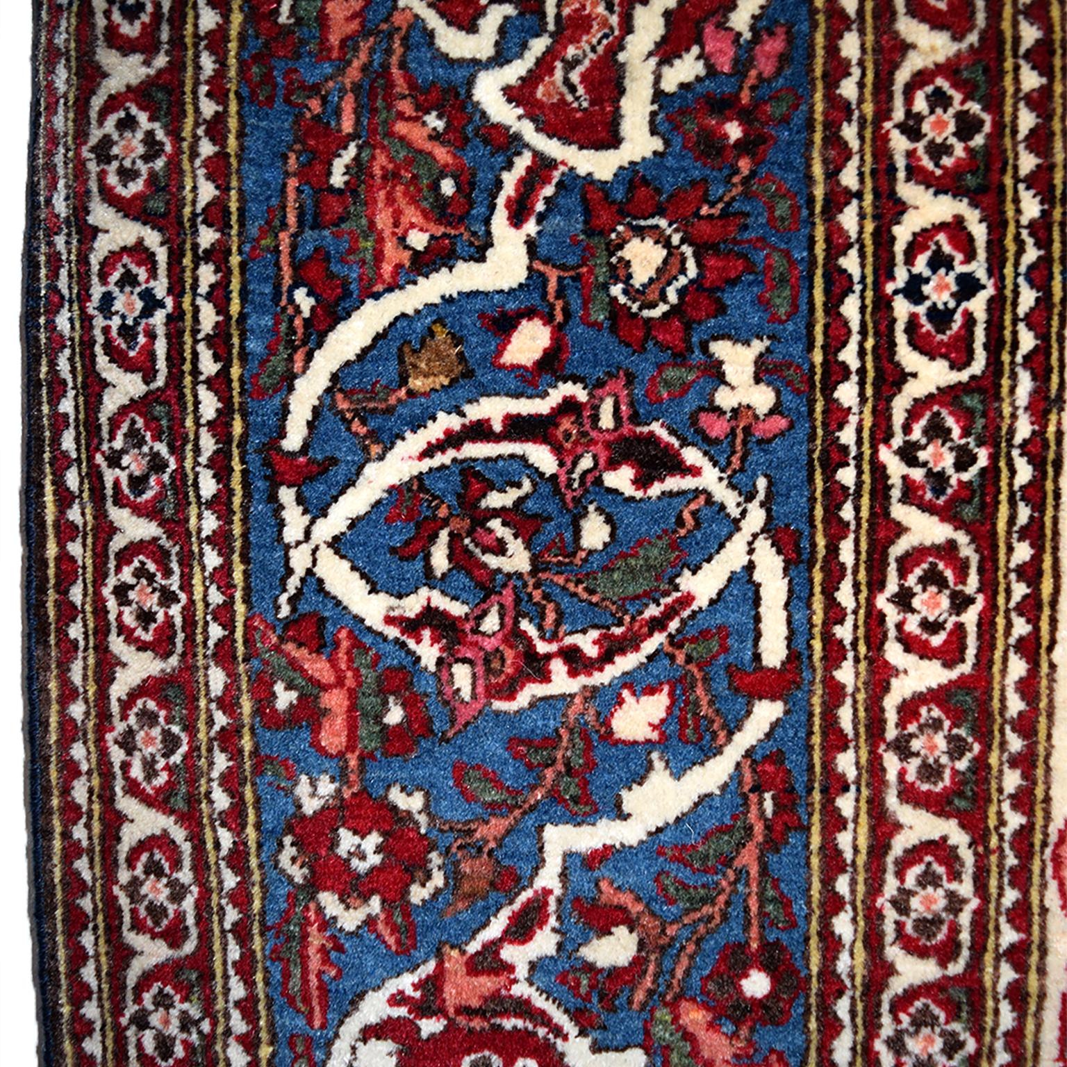 This Persian Isfahan Tree of Life carpet, circa 1890-1900, features a gateway to paradise design anchored by four phoenixes. The phoenix of Persian myth and folklore represents a spiritual guide, a bird of light and enlightenment and spiritual