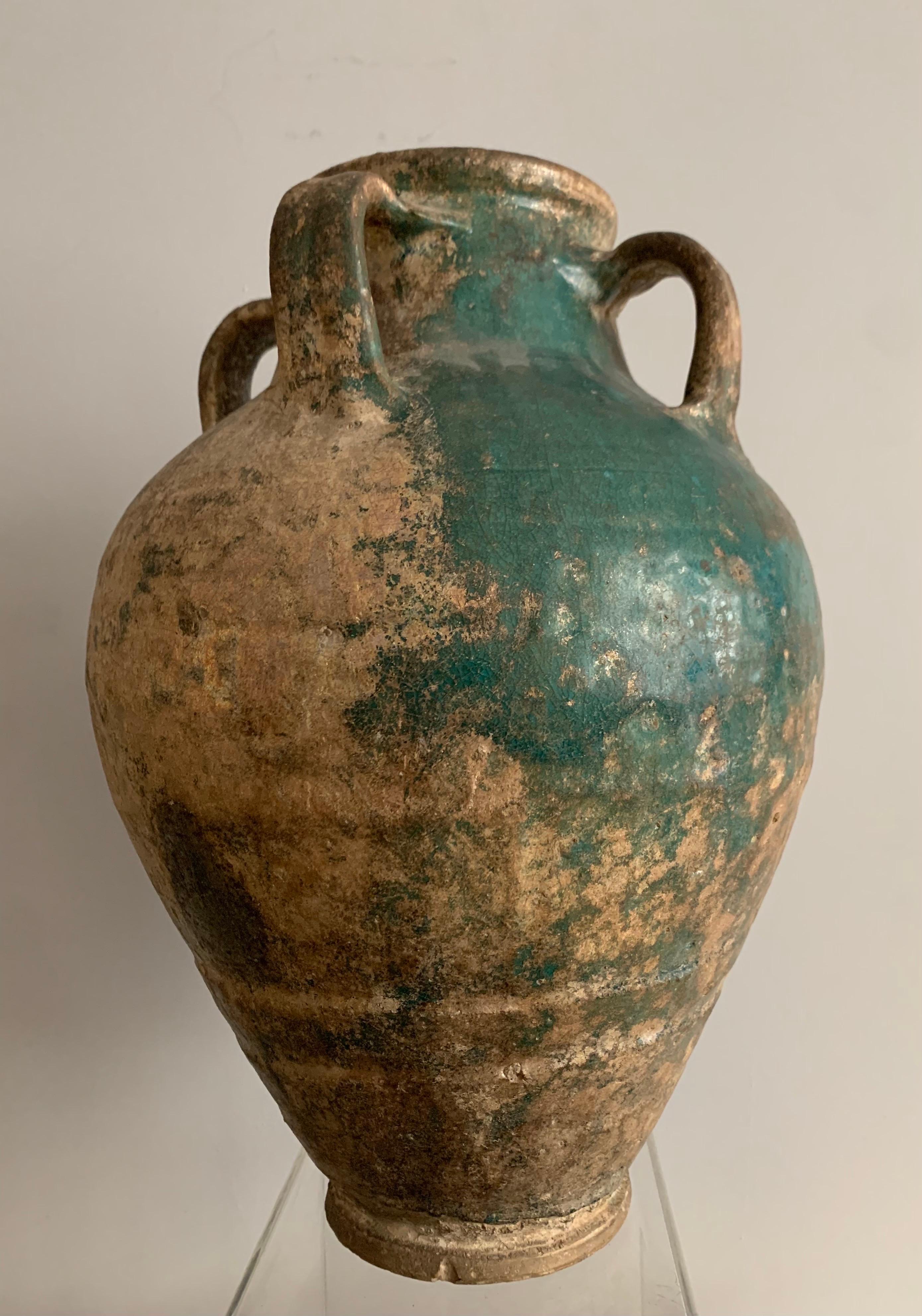 Four handle jar
Turquoise glazed earthenware storage jars of this type are an ancient form in the Gulf region. 
Technical studies have now established that this jar type was produced at and around Basra, the early medieval port city serving Baghdad.