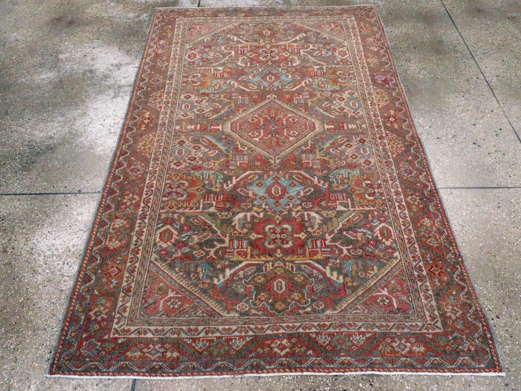 An antique Persian Mahal small accent rug handmade during the early 20th century with a design inspired by Persian Karajeh carpets.

Measures: 4' 3