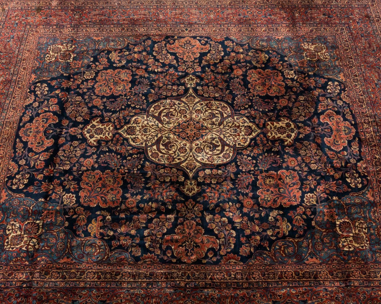 Antique Caucasian rug with a dramatic central pendant flanked by various scrolled medallions and sweeping arabesque caves, circa 19th century.
 