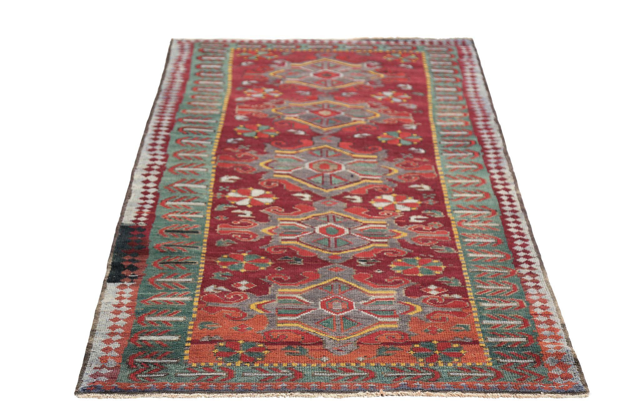 Entdecken Sie die Eleganz des persischen Kazak mit dem kleinen Teppich von CIRCA 1940. Dieses exklusive Design aus Wolle und GrünRotGelb ist perfekt, um Ihren Raum zu verschönern.