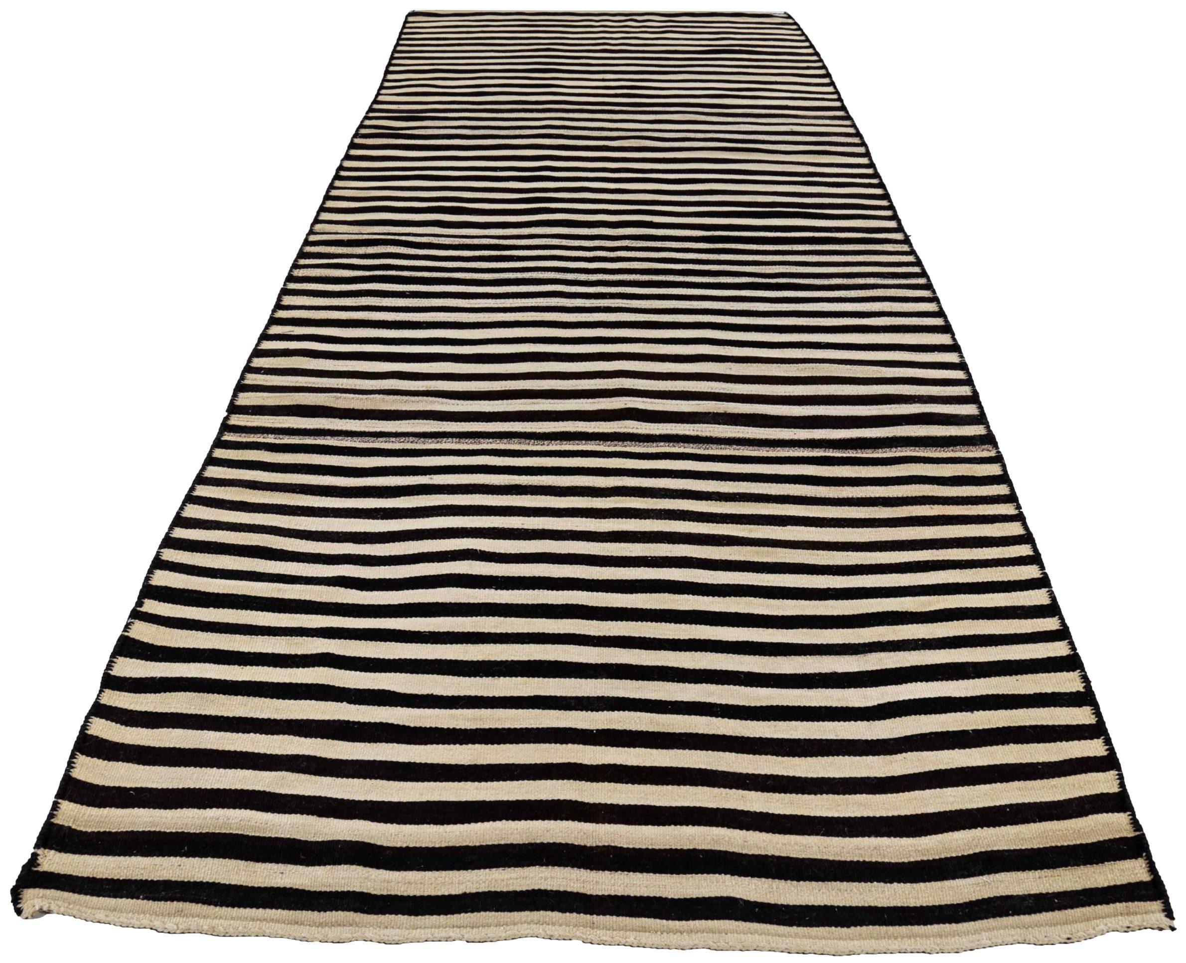 Discover the elegance of Persian Kilim featuring Area Rugs in Circa 1910. Designed with Wool and BlackIvory, this exclusive design is perfect for enhancing your space.