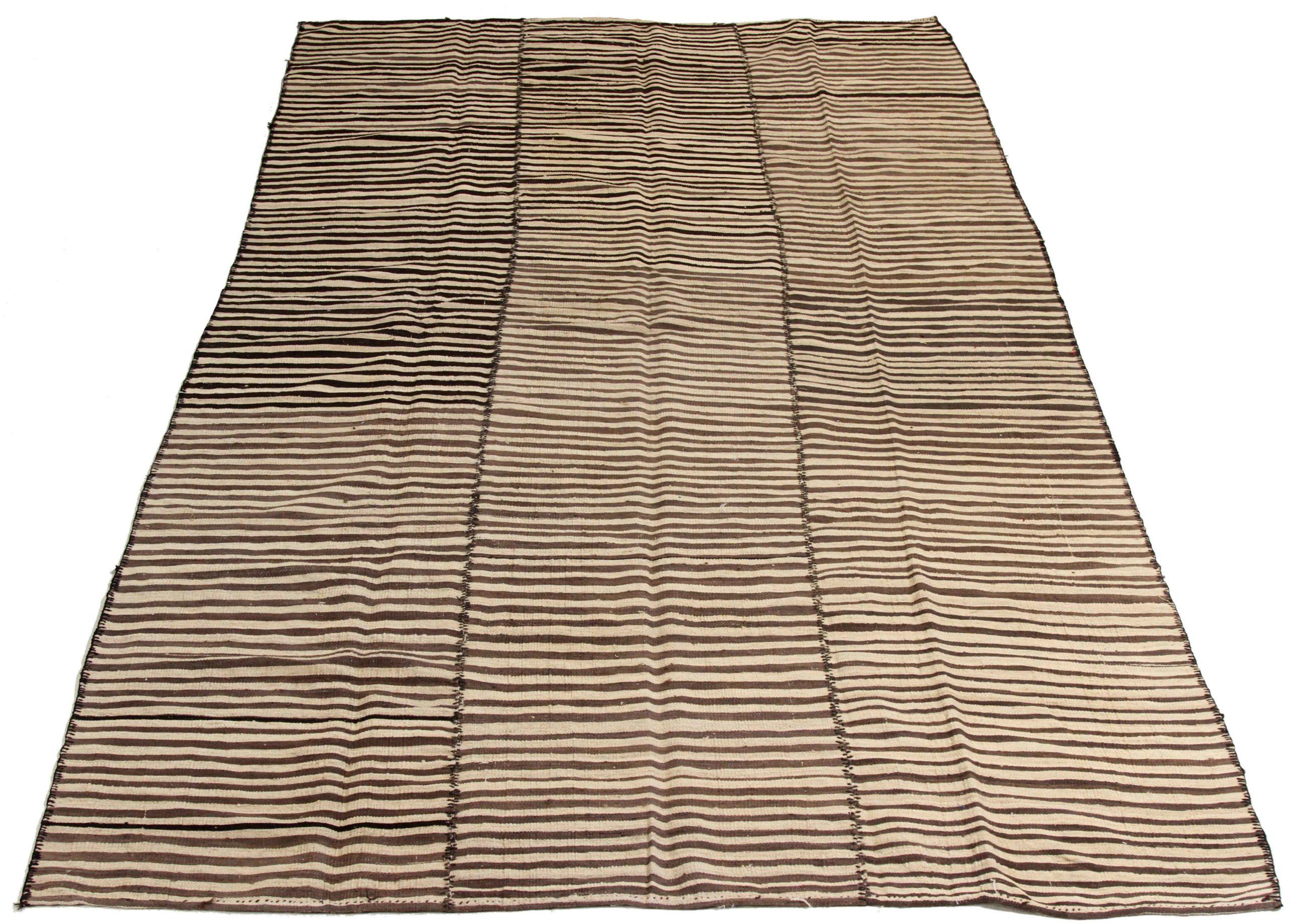 Discover the elegance of Persian Kilim featuring Area Rugs in Circa 1910. Designed with Wool and BrownIvory, this exclusive design is perfect for enhancing your space.