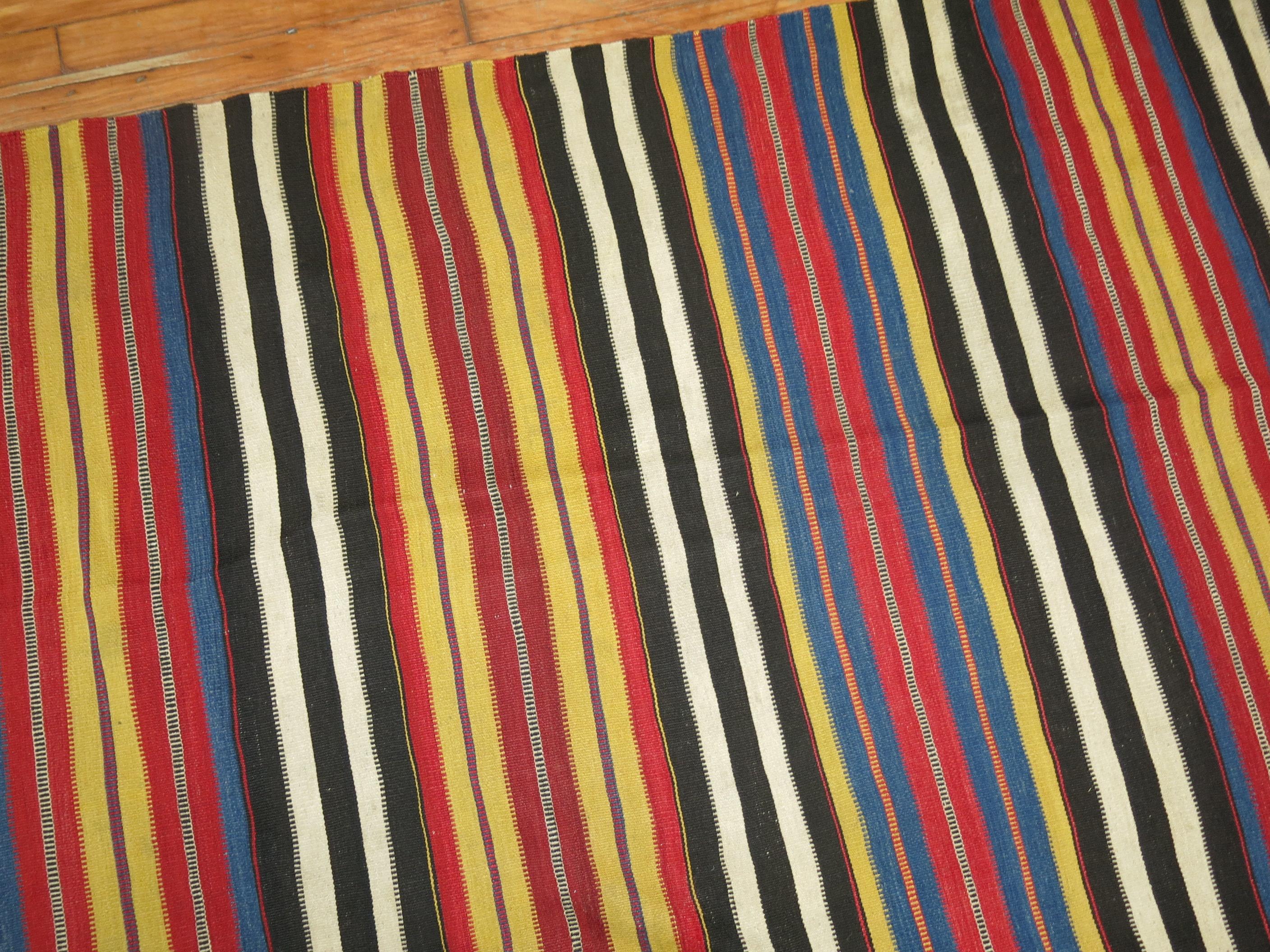 An intermediate size striped finer quality Vibrant Persian Kilim from the early stages of the 20th century,

circa 1920, measures: 5'10