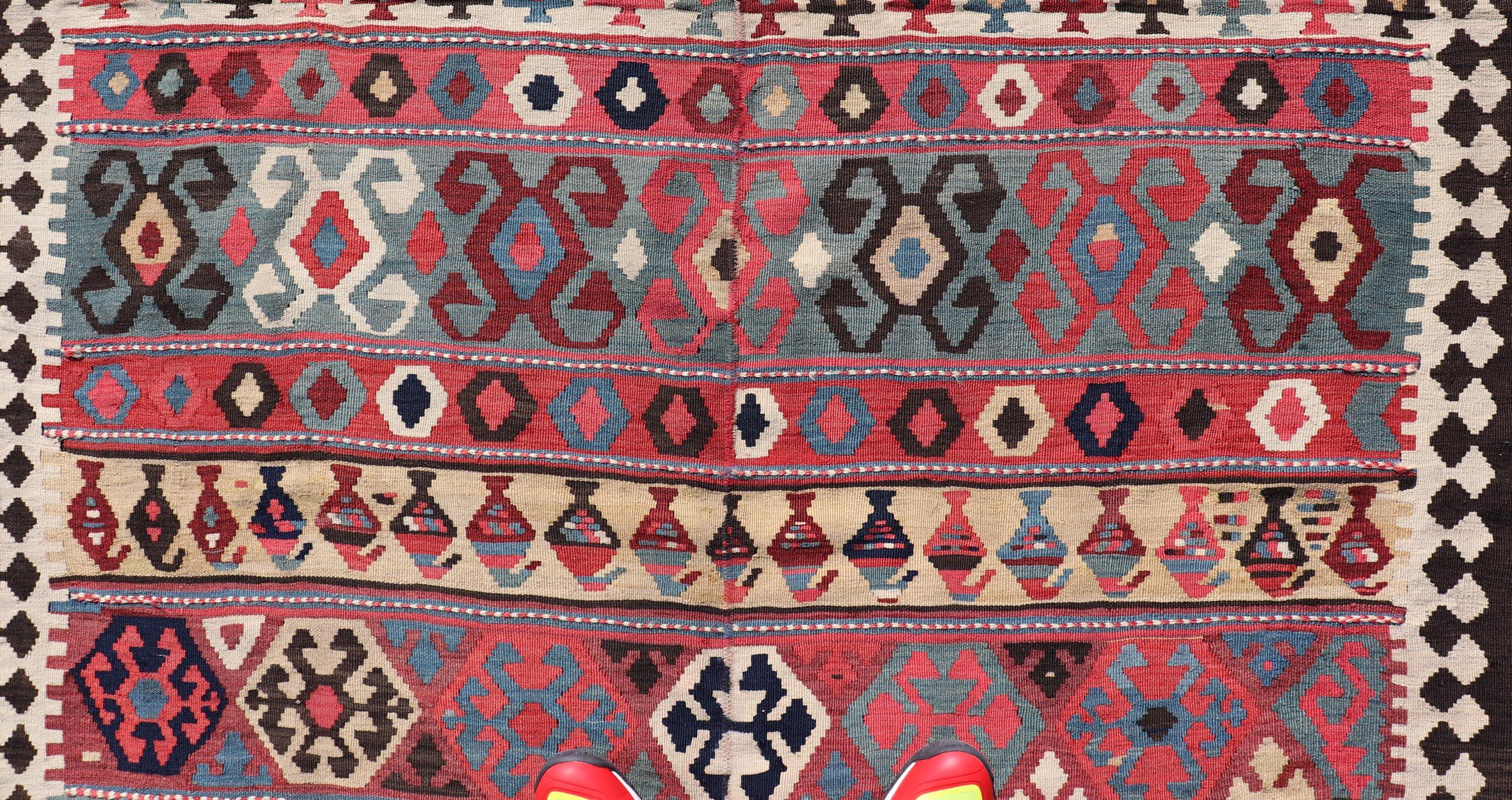 Wool Persian Kilim Rug with Bold Tribal Geometric Patterns in Vivid Colors 4'9 x 6'9 For Sale