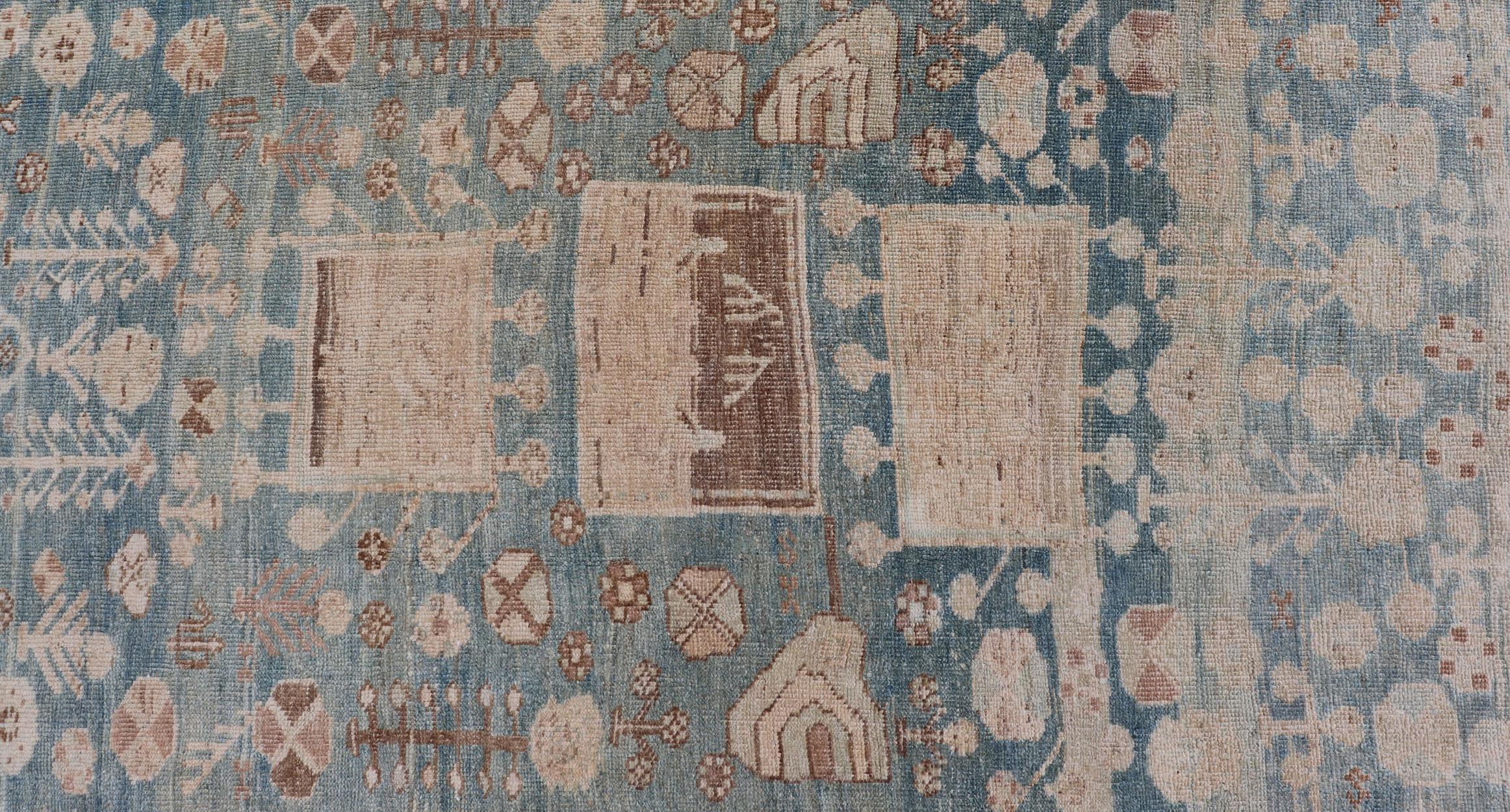 Antique Kurdish rug with tribal geometric medallions in soft blue, cream, light blue, medium blue with hint of teal, brown, tape, and cream in the border. 
Keivan Woven Arts / rug EMB-9599-P13503, country of origin / type: Iran / Kurdish, circa