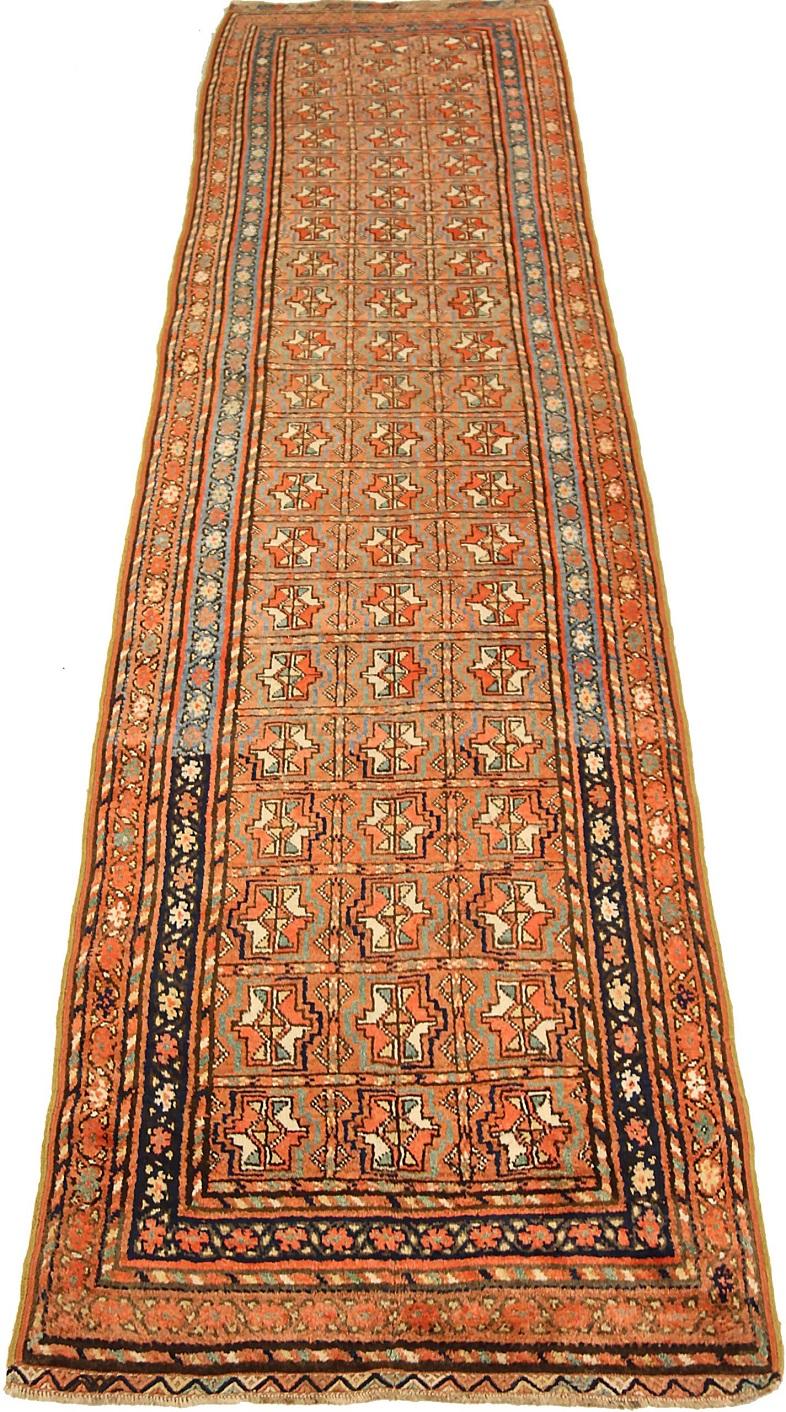 Entdecken Sie die Eleganz des persisch-kurdischen Läuferteppichs aus der Zeit um 1910. Dieses exklusive Design aus Wolle und Blau-Elfenbein-Rot ist perfekt, um Ihren Raum zu verschönern.