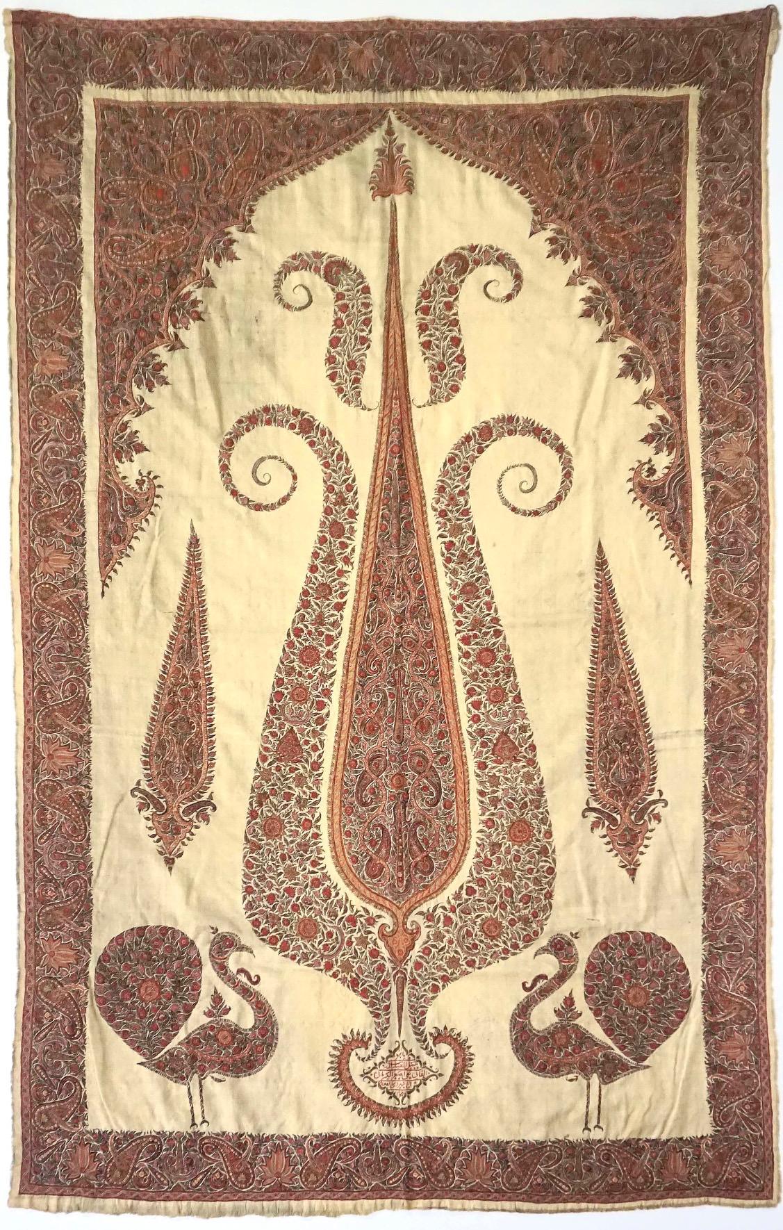 An exquisite intricately embroidered circa 1840 Persian Kerman Pateh, or curtain panel, with boteh (paisley) and floral border surrounding field with stylized cypress tree in cusped niche composed of same boteh and flowers, the bottom with facing