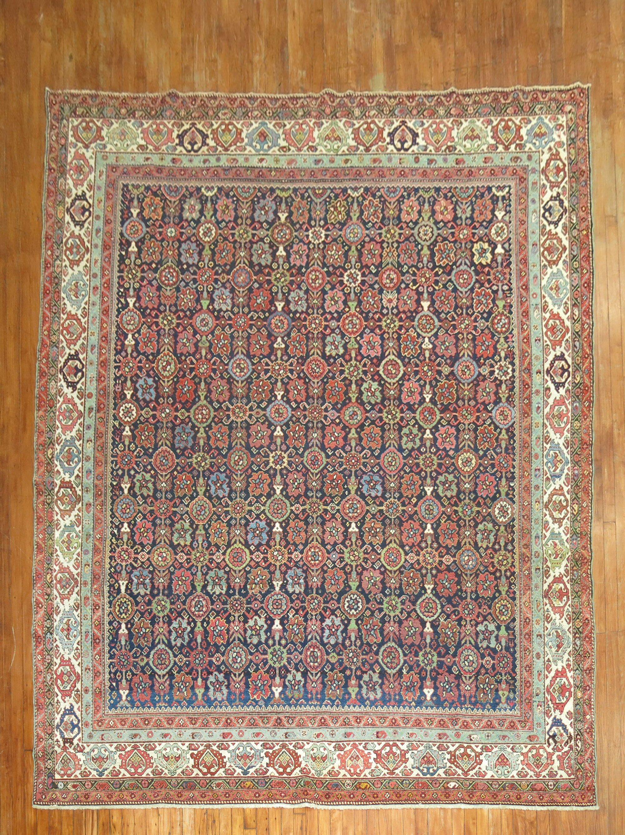 Decorative early 20th-century Room size Persian Malayer rug with a mini Khani design on a navy ground

Measures: 8'9'' x 11'1''.