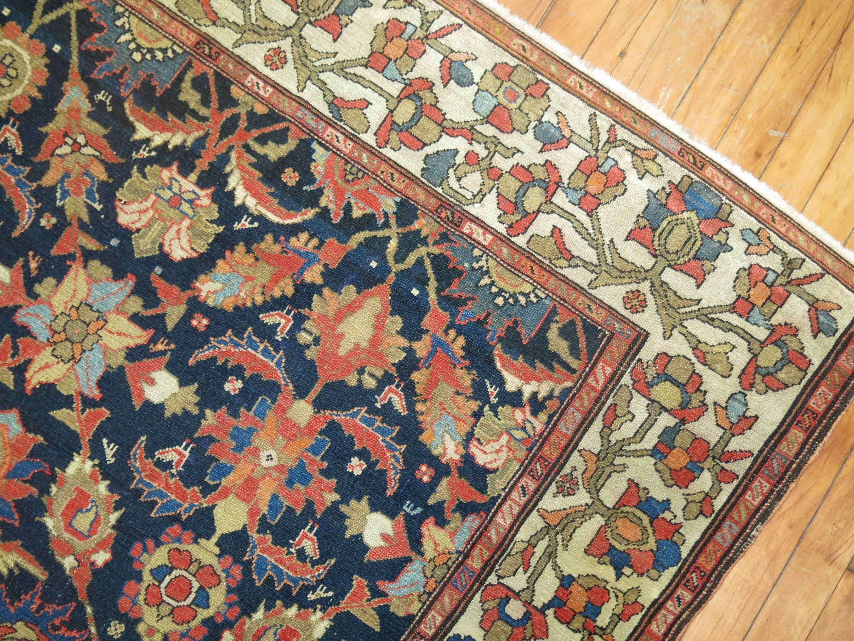 Finely woven authentic Early 20th century Persian rug with navy background and rustic tones. 