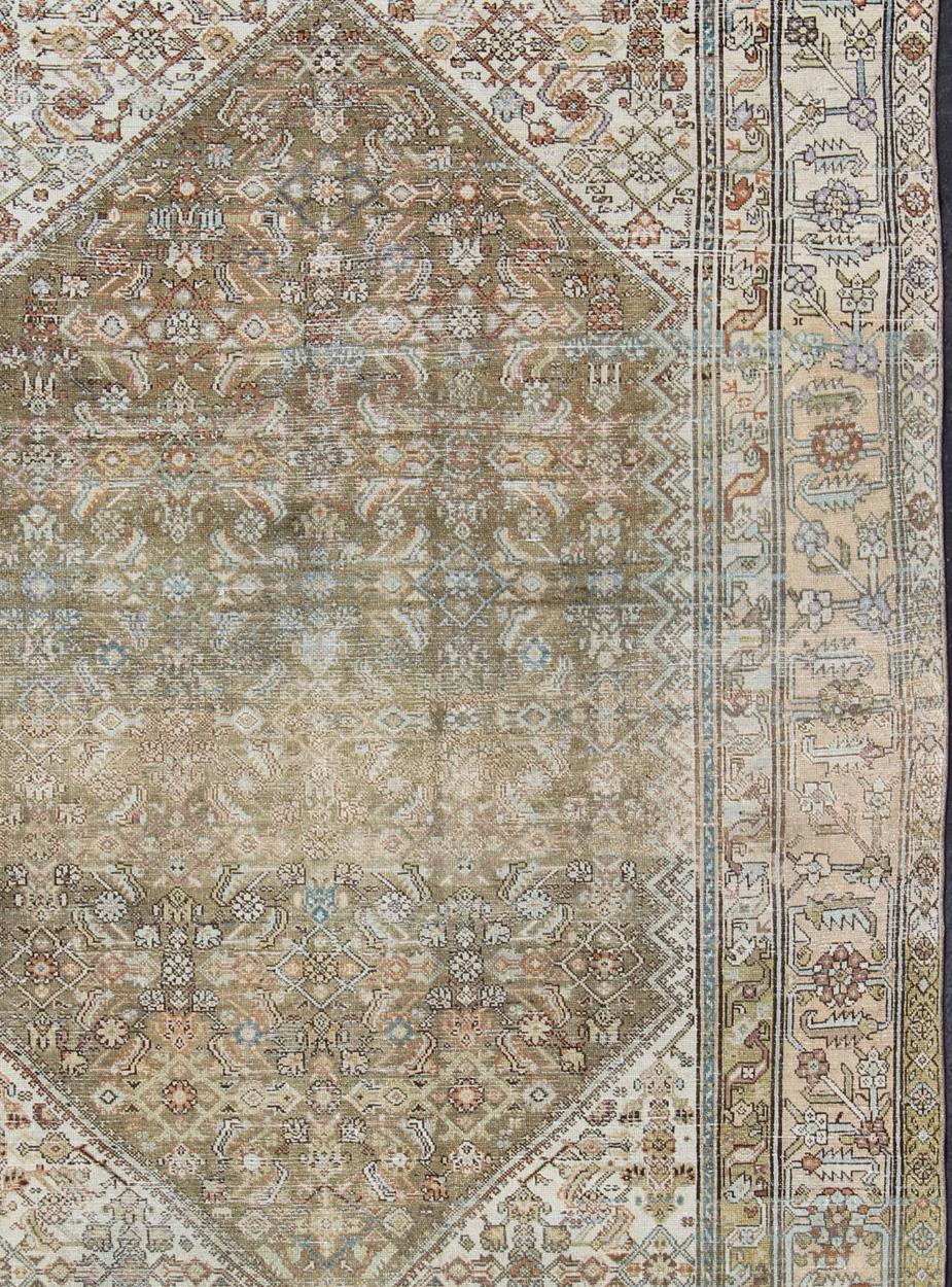 Antique Persian rug with faded green field and ivory cornices, Border, rug SUS-1908-275, country of origin / type: Iran / Malayer, circa 1900.

This traditional Persian Malayer carpet from the early 1900s is characterized by a central field full