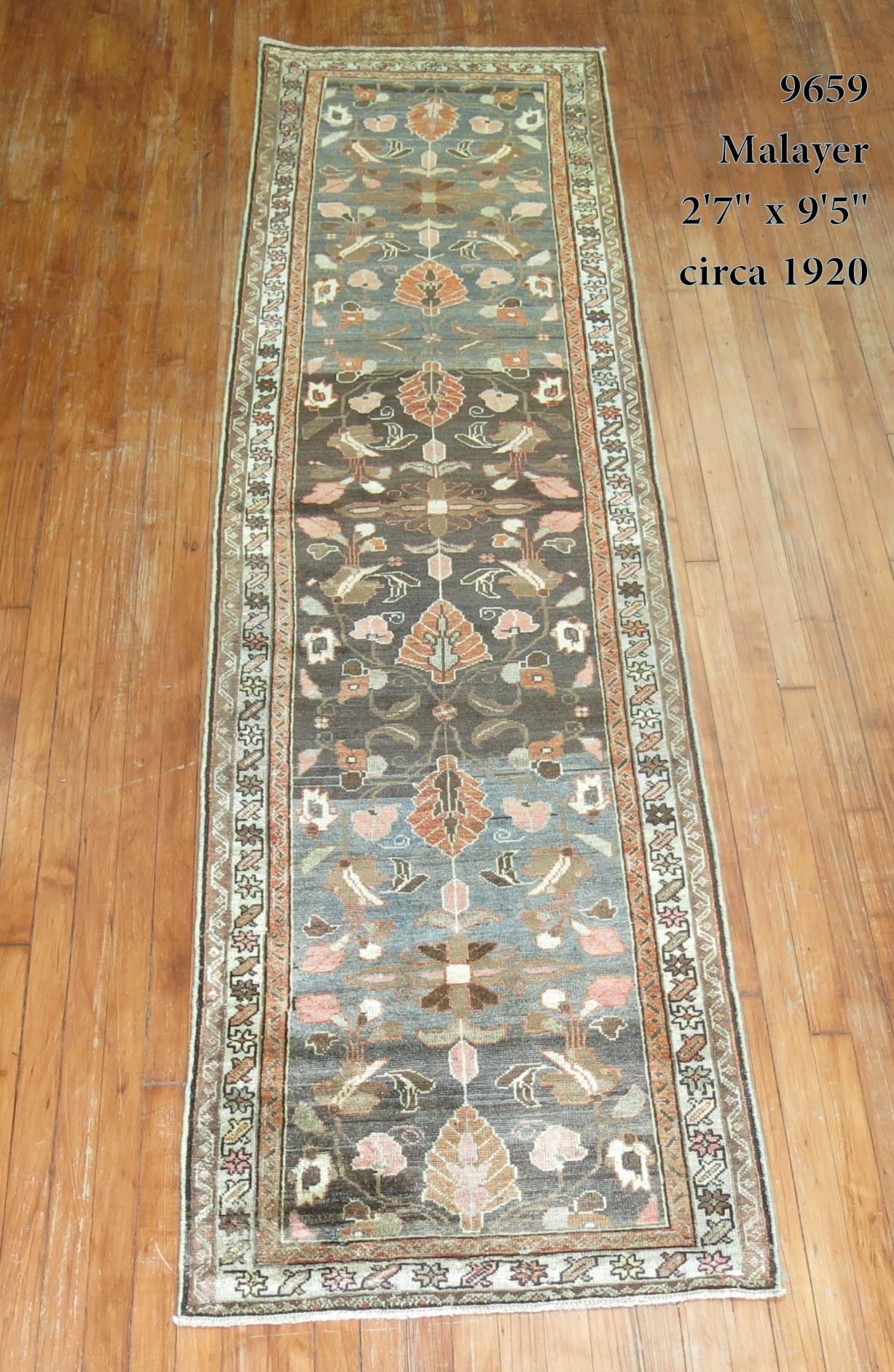 Early 20th century Persian Malayer rug. Predominantly in brown, gray, shades of green.
The color variations in the field are referred to as abrash. Abrash is a term used to describe color variations found in hand knotted Oriental rugs. Although